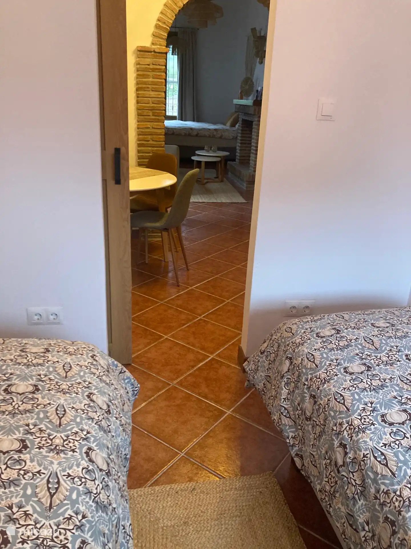 Uitzicht vanuit slaapkamer 2 waar 2 losse eenpersoonsbedden staan.