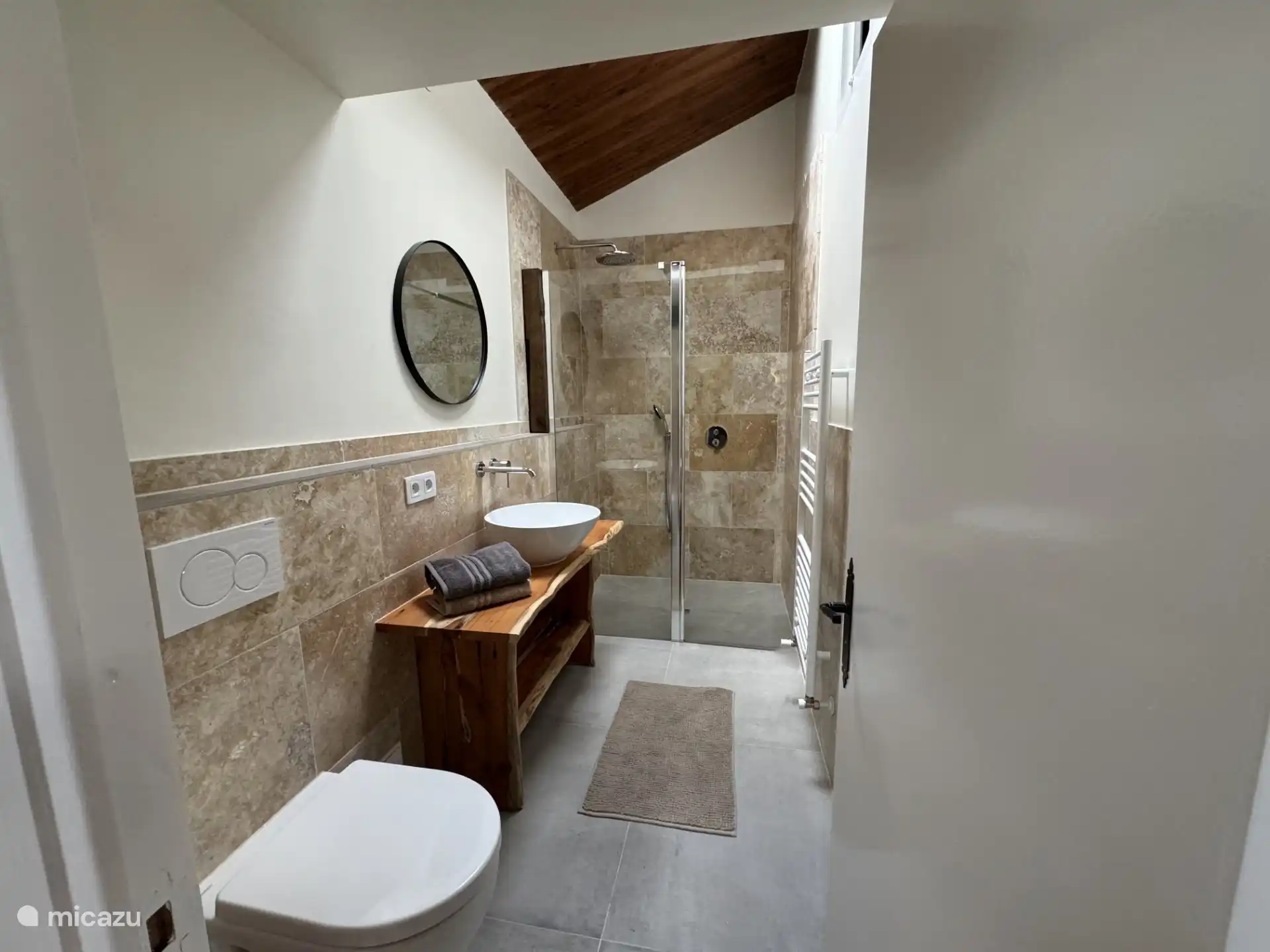 Bathroom on the first floor with walk-in shower, sink and toilet.