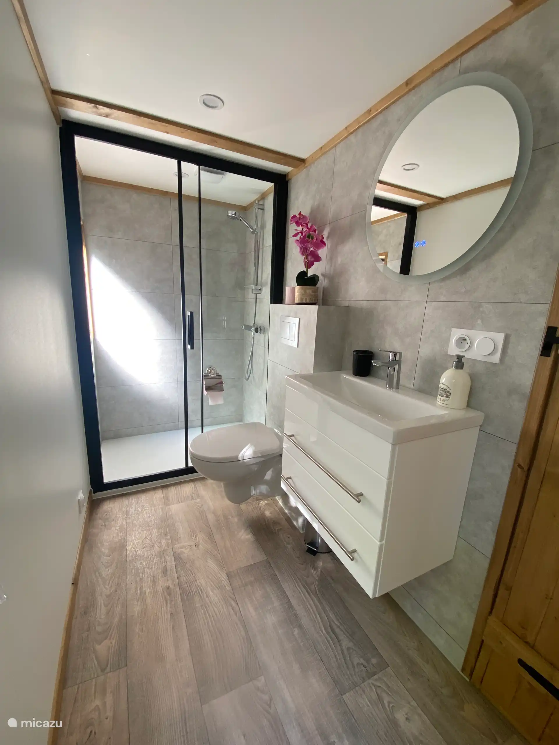 Mobile home bathroom with sink, toilet and shower.