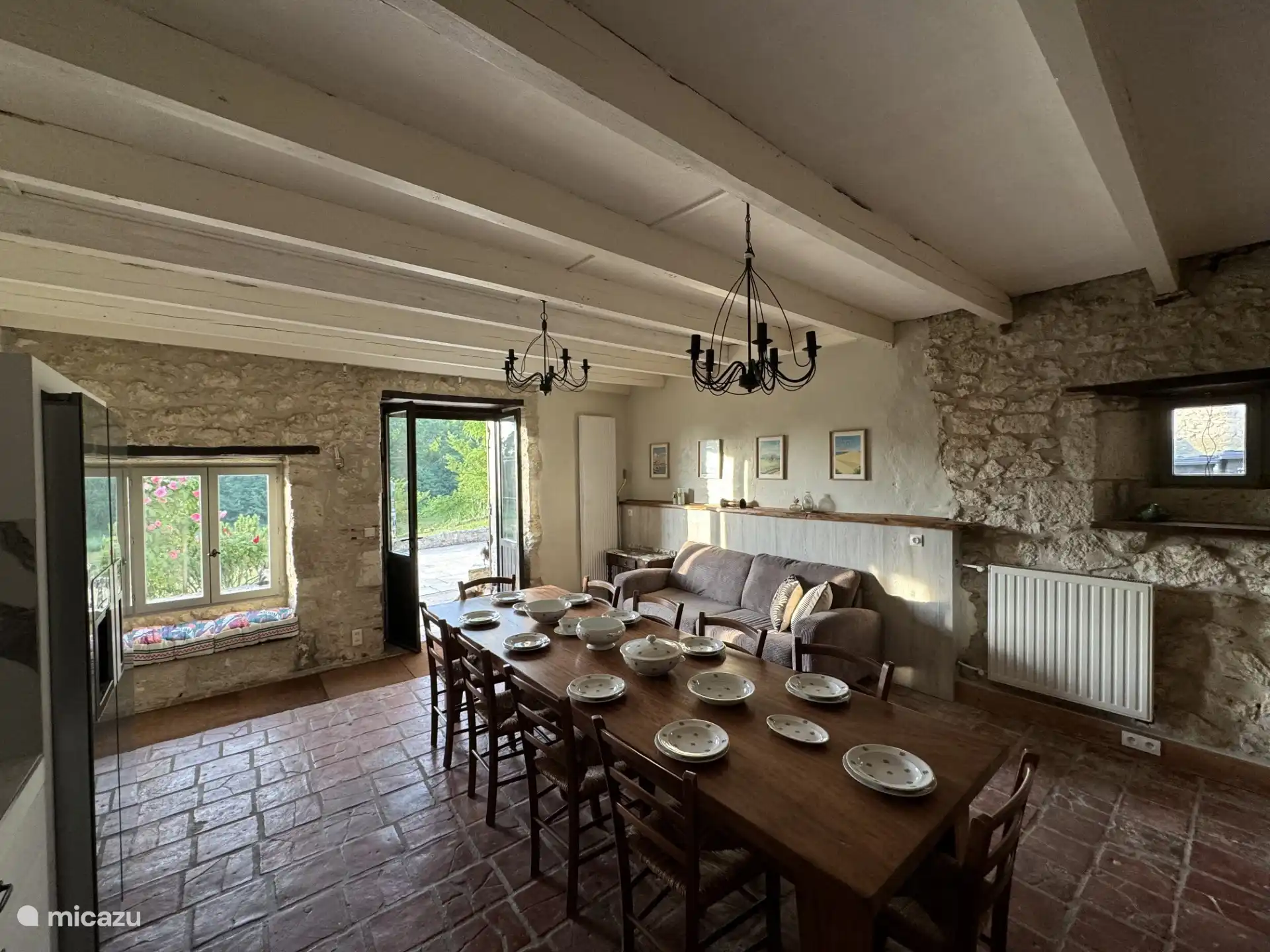 Spacious, fully equipped kitchen with large dining table.