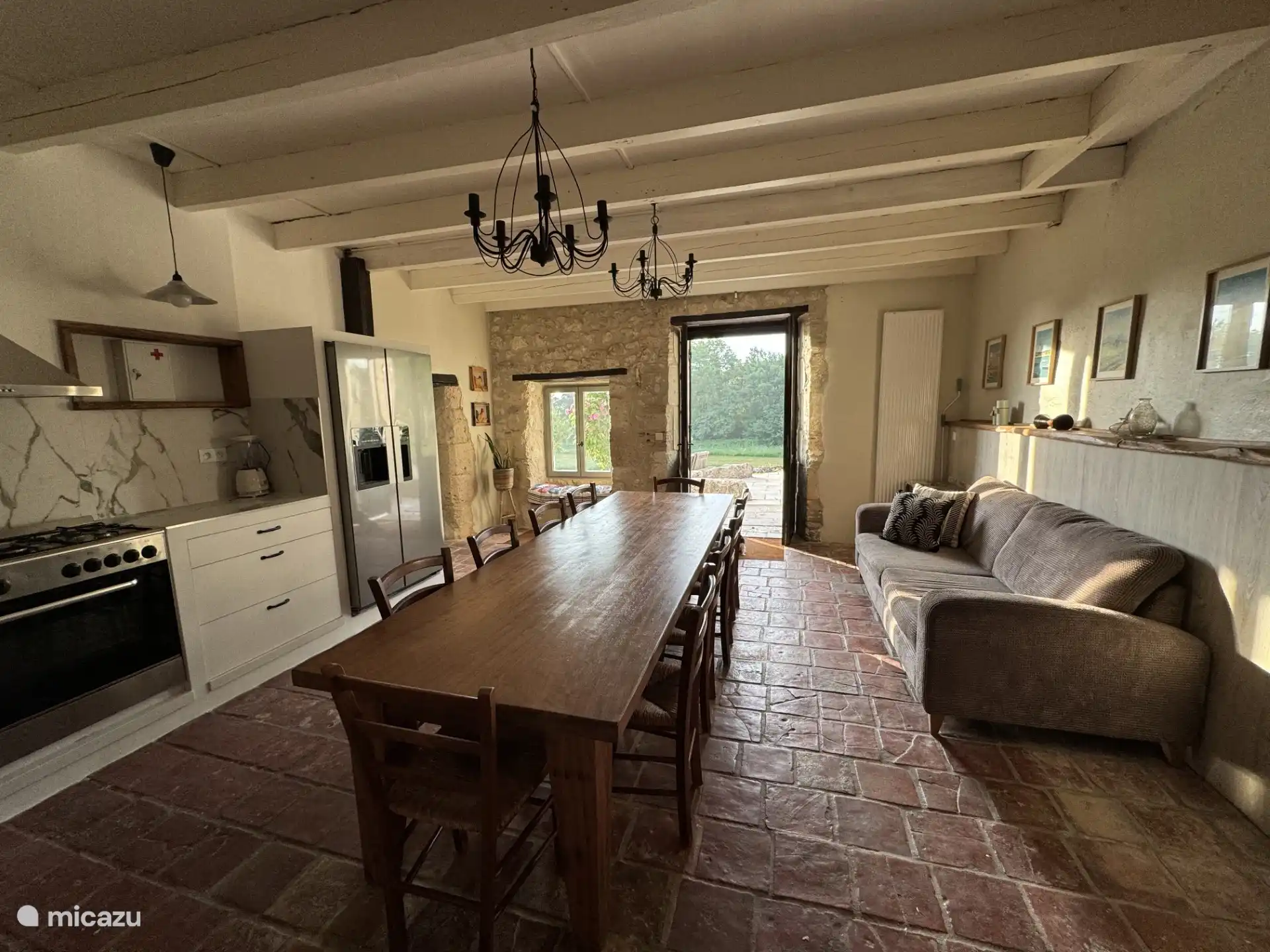 Spacious, fully equipped kitchen with large dining table.