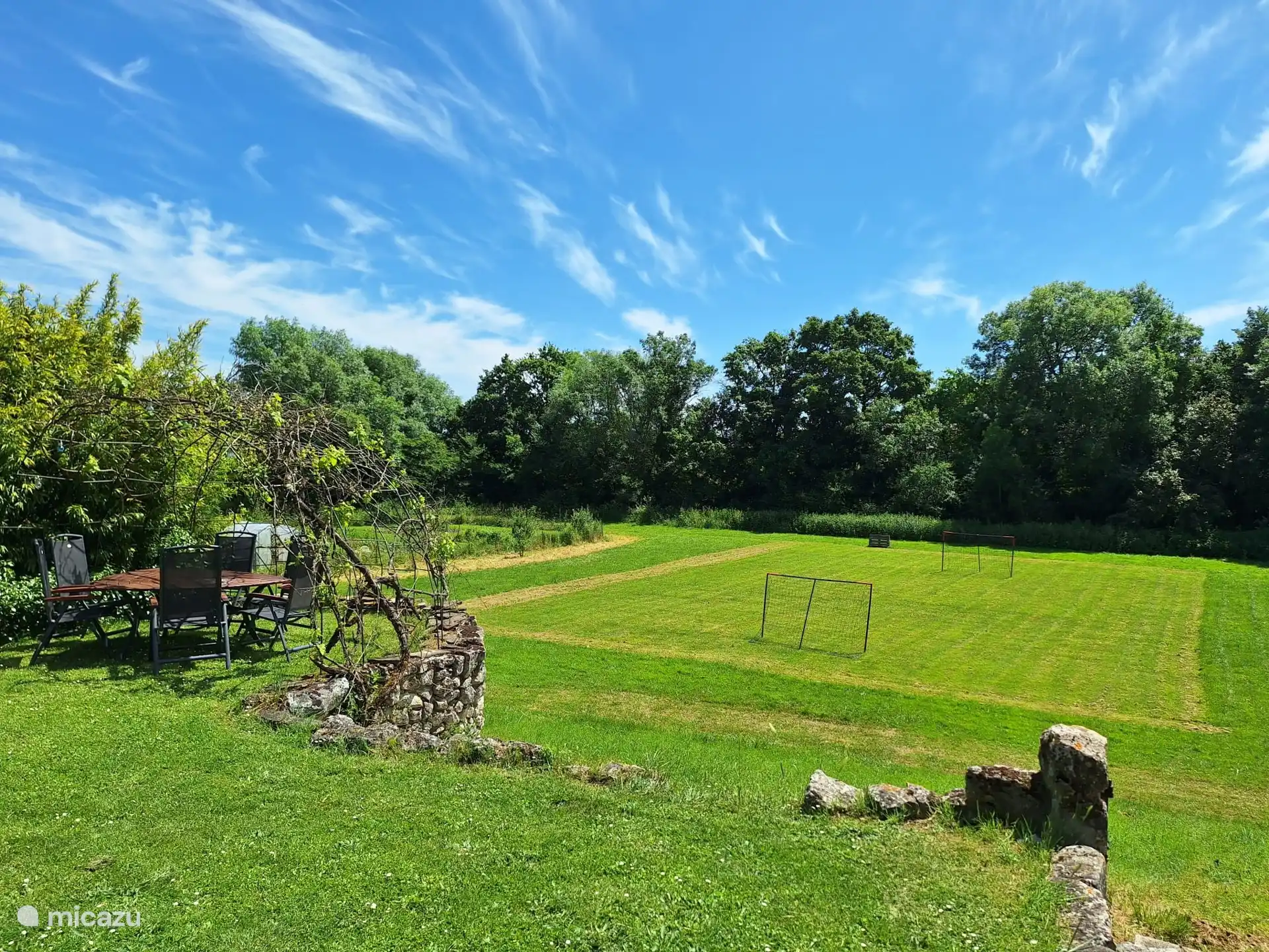 Large field with space to play, including football goals and footgolf. View from terrace gite.