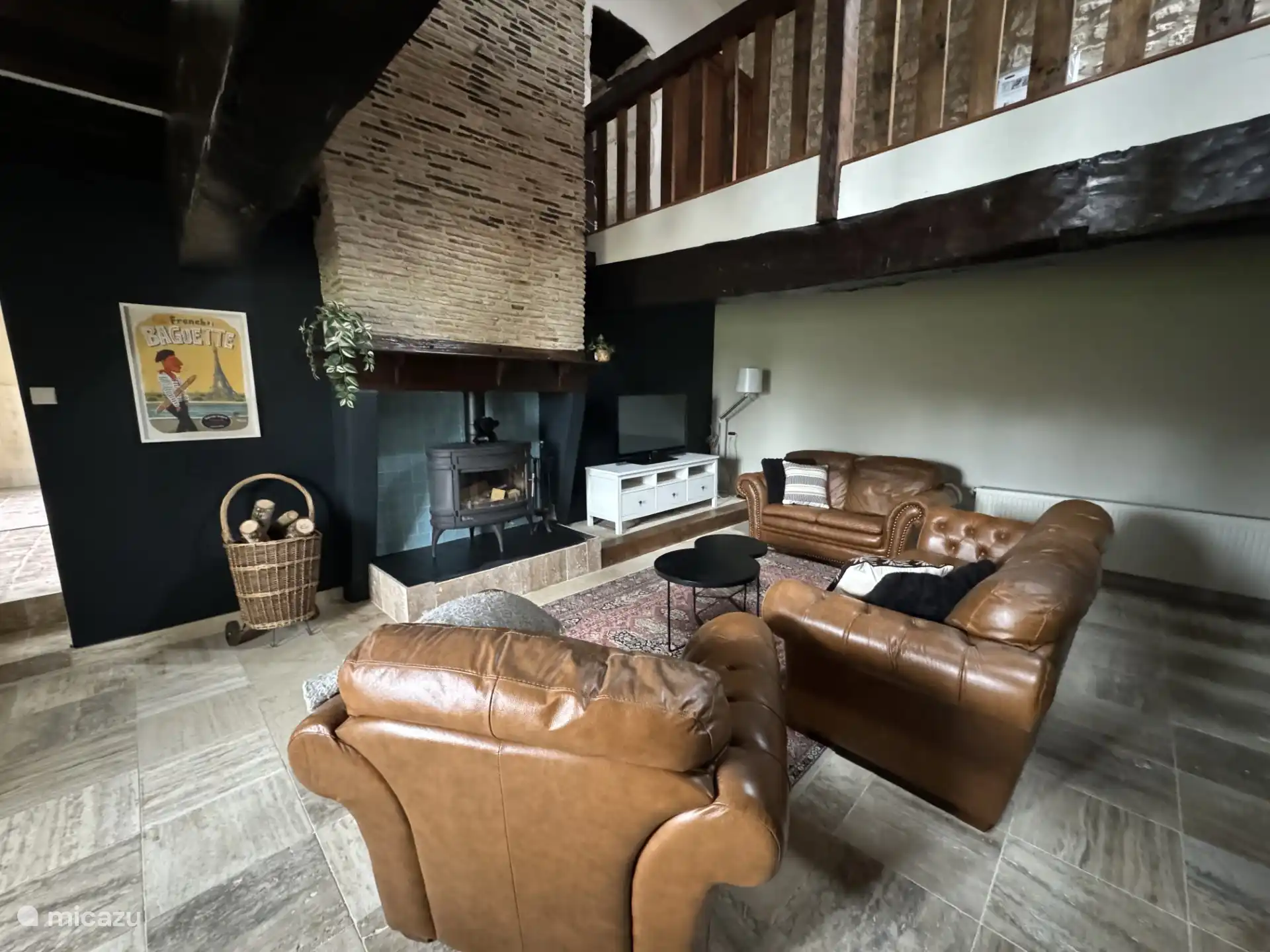 Cozy living room with comfortable sitting area and wood stove.