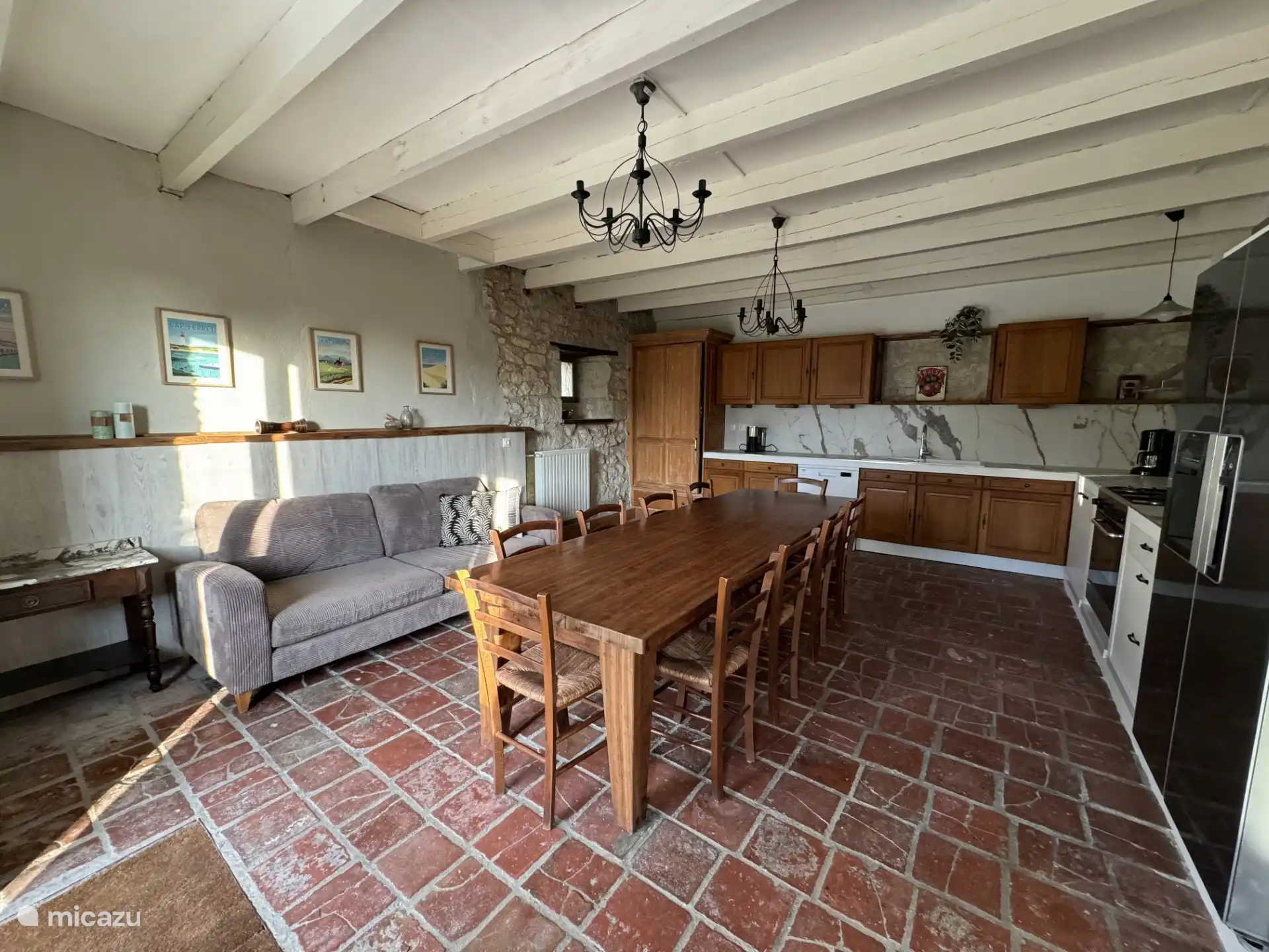 Spacious, fully equipped kitchen with large dining table.