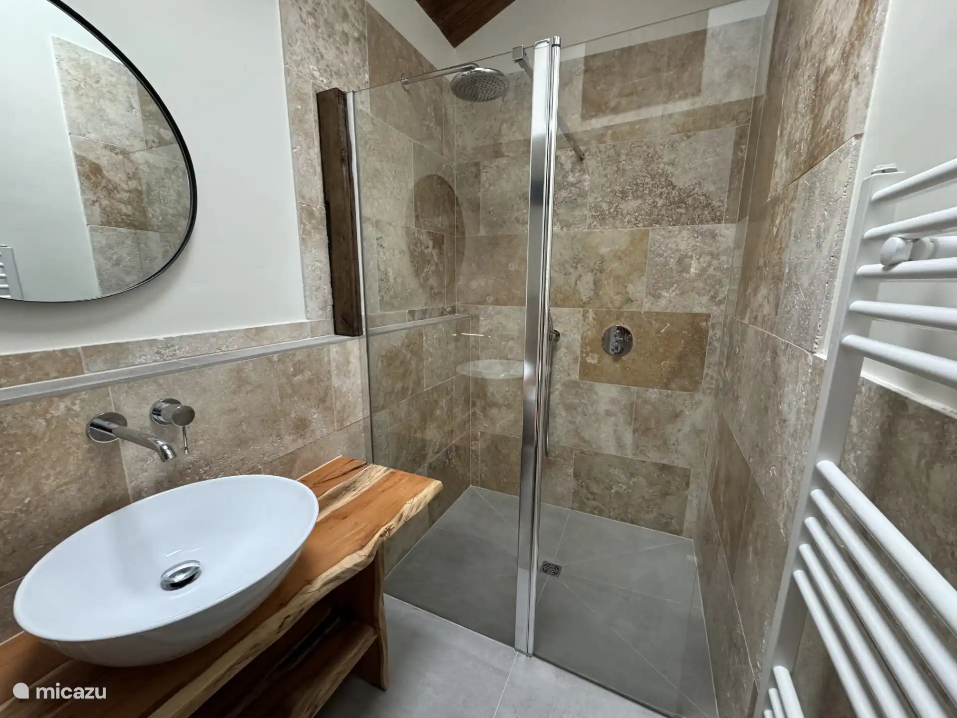 Bathroom on the first floor with walk-in shower, sink and toilet.