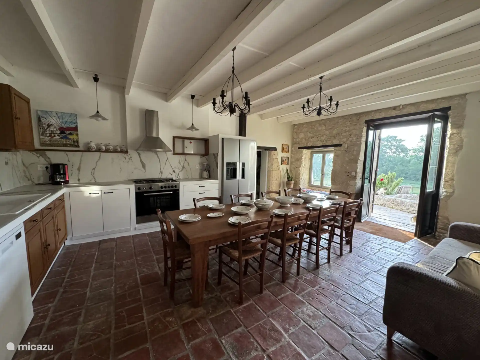 Spacious, fully equipped kitchen with large dining table.