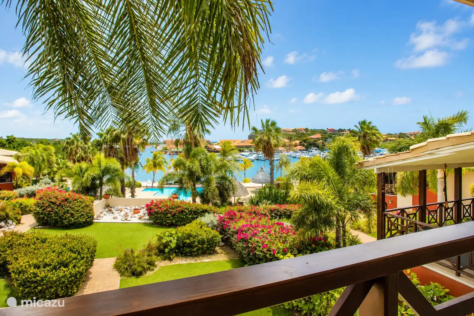 View from the balcony over the tropical garden, the pool and the Spanish Water.