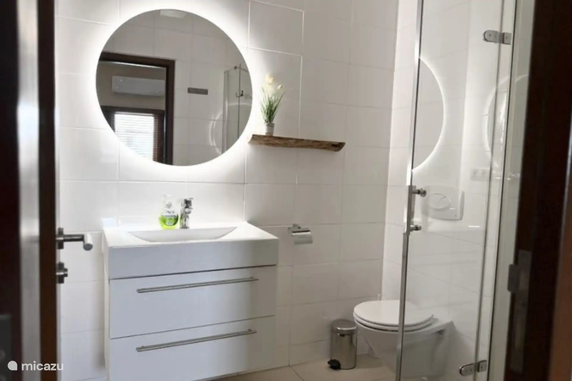 Bathroom with sink, mirror and walk-in shower.