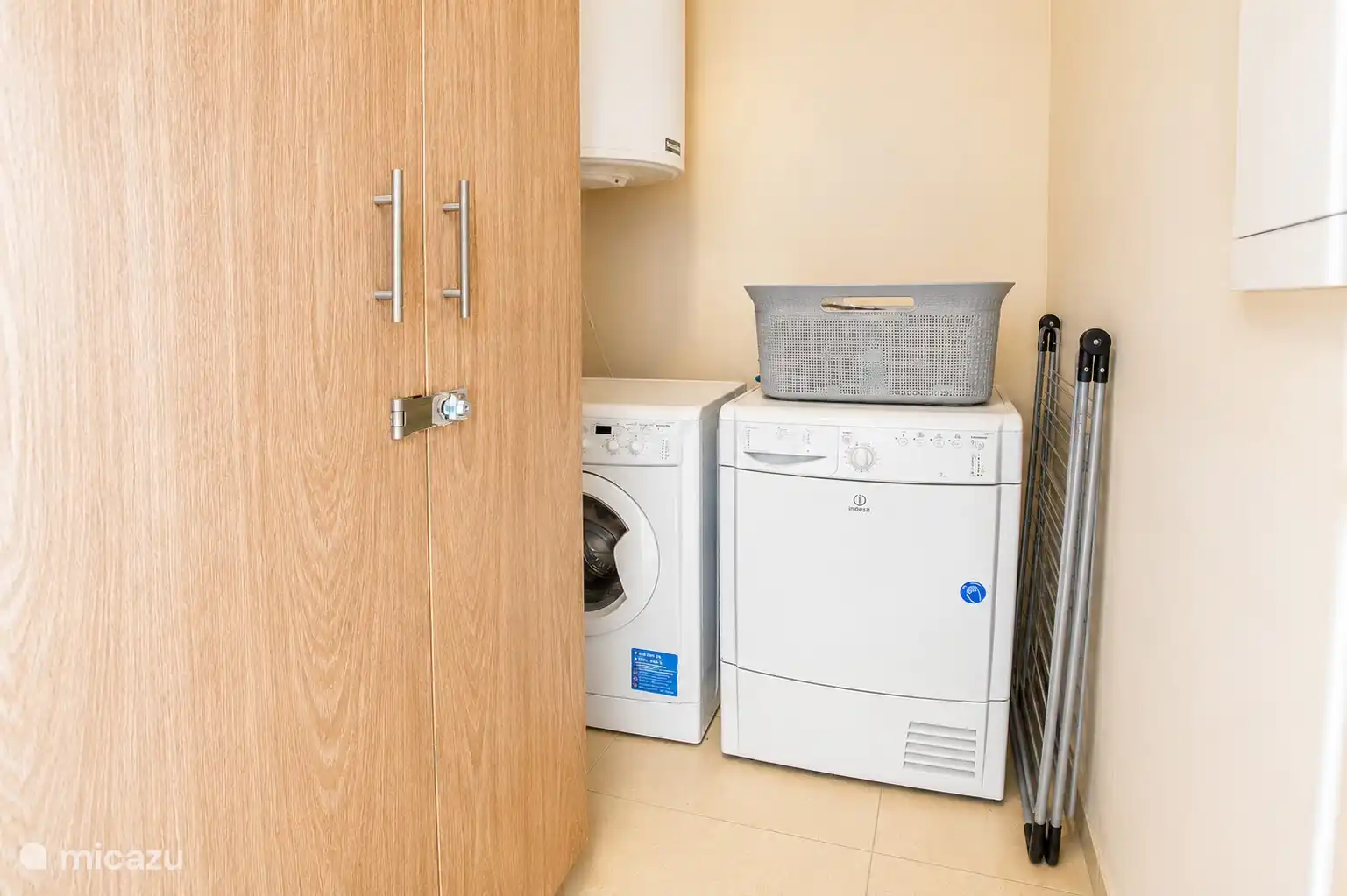 Practical laundry room with washing machine, dryer and extra amenities for a comfortable stay.