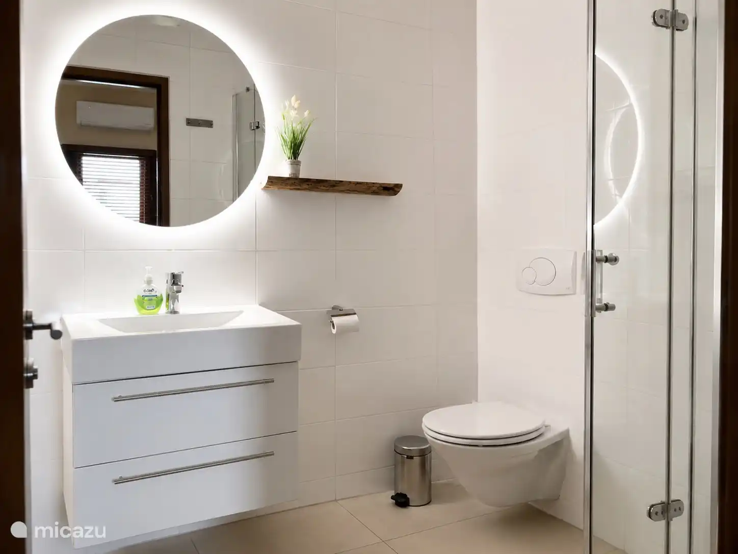 Bathroom with sink, mirror and shower.