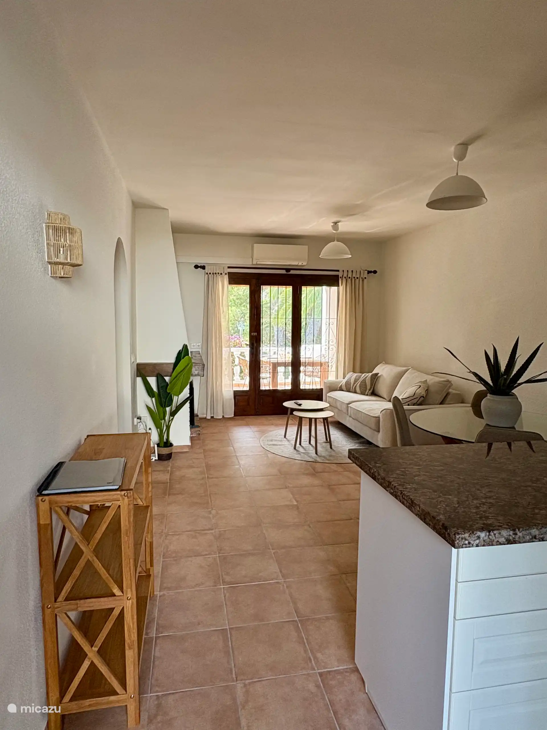 Living room with 3 seater sofa, air conditioning and a smart TV. Dining area with round dining table and 4 dining chairs. - Living-dining room