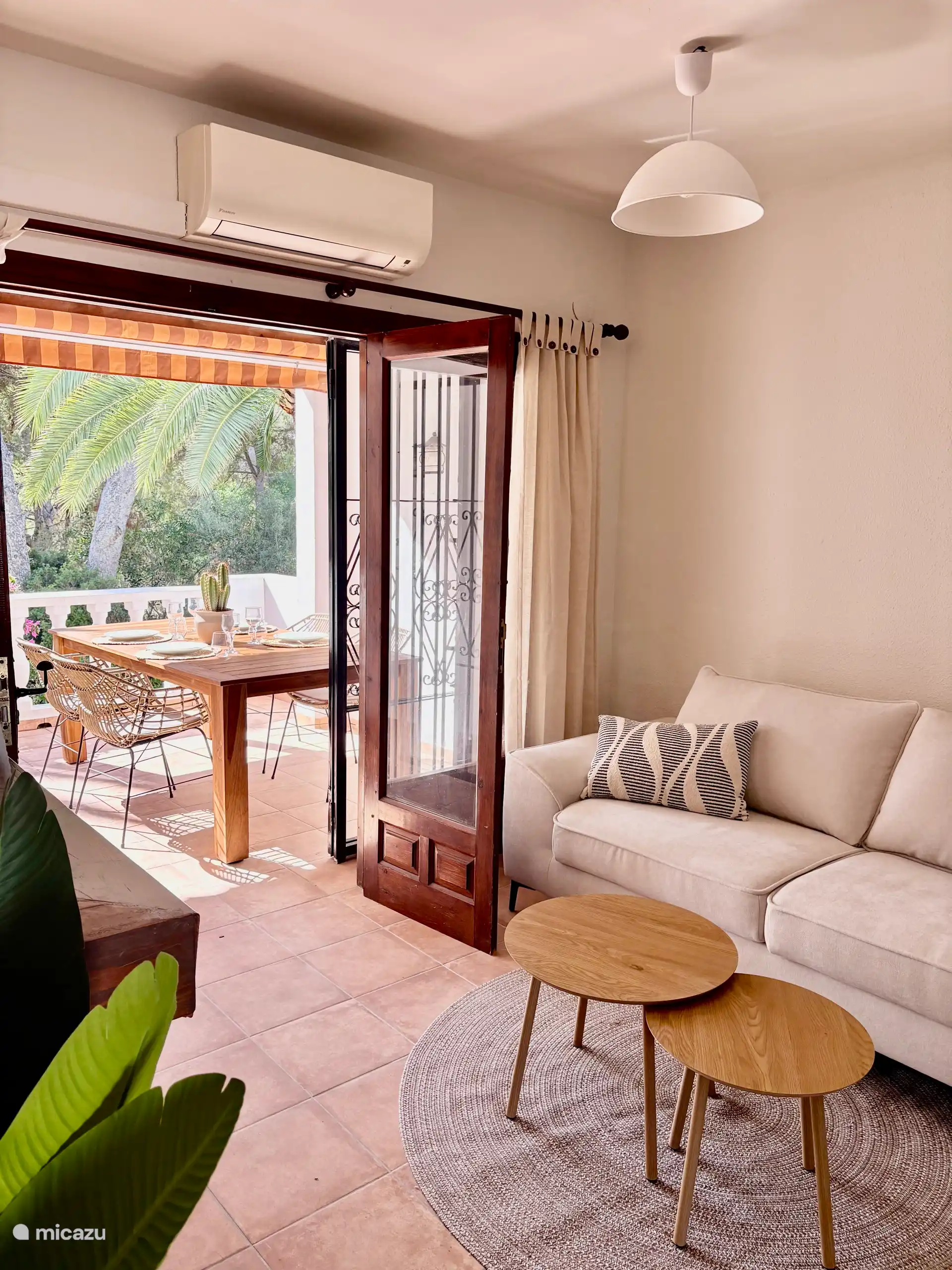 Living room – traditional patio doors offer beautiful, spacious views of the balcony and palm trees - Living-dining room