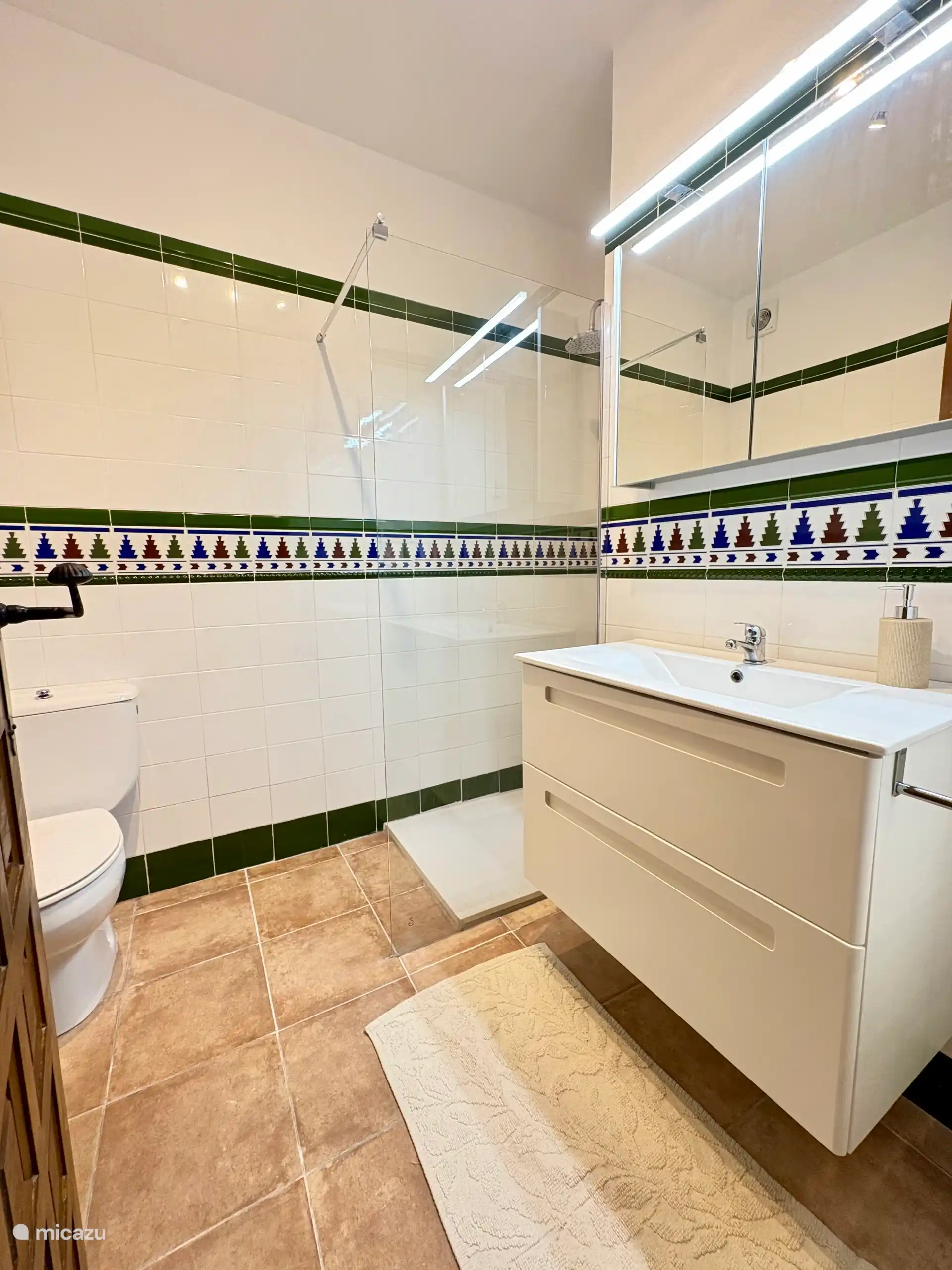 A bright, simple white bathroom with a walk-in shower and good lighting - Bathroom