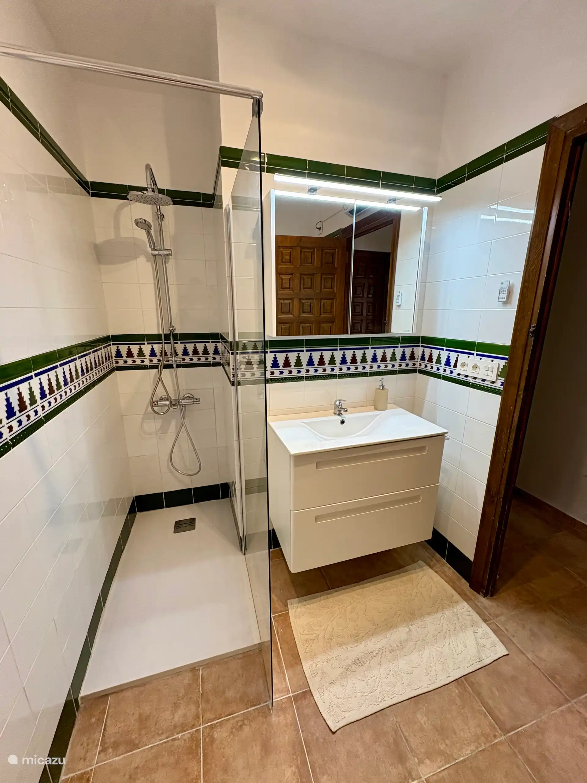A bright, simple white bathroom with a walk-in shower and good lighting - Bathroom
