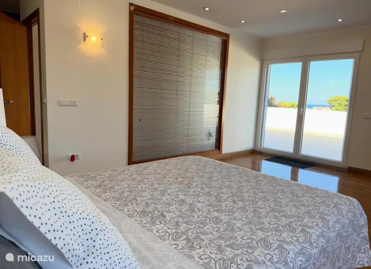 Bedroom 1 on top floor with direct access to very large terrace and sea views from the bed. 