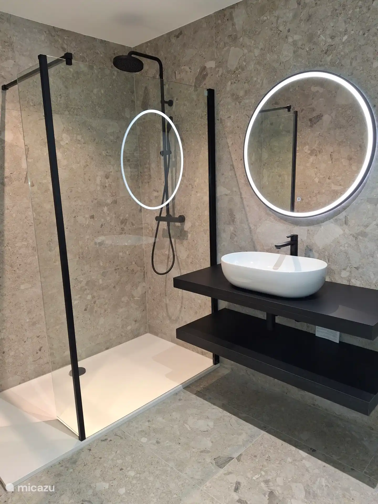 Walk-in shower with rain shower head and hand sprayer. Illuminated heated mirror.