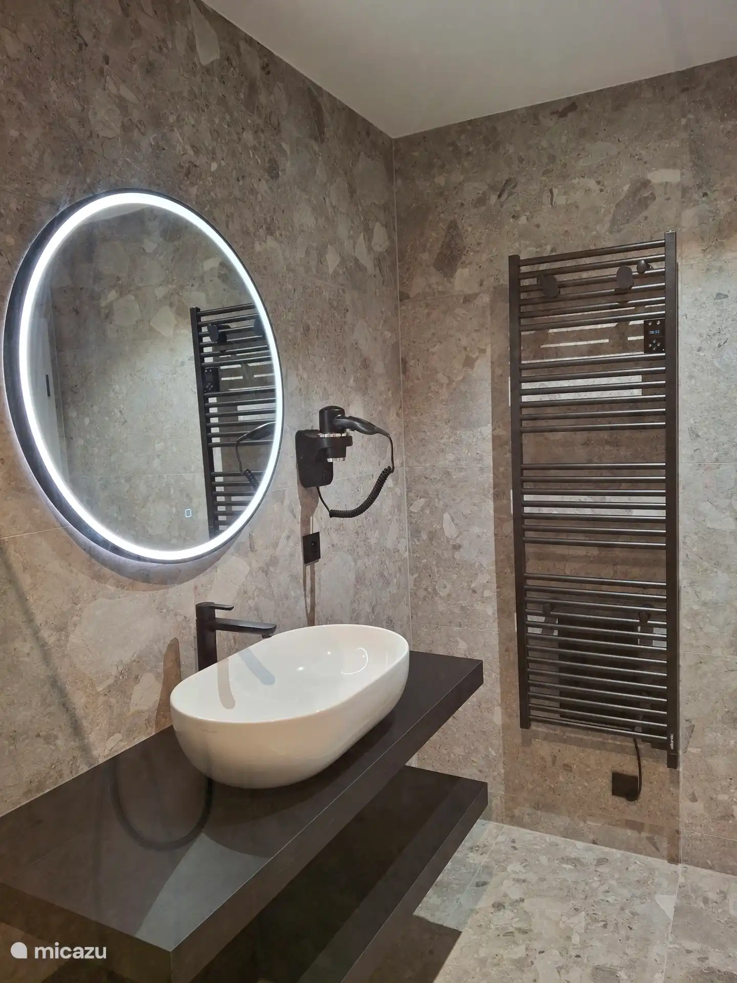 Shower room equipped with towel radiator and hairdryer