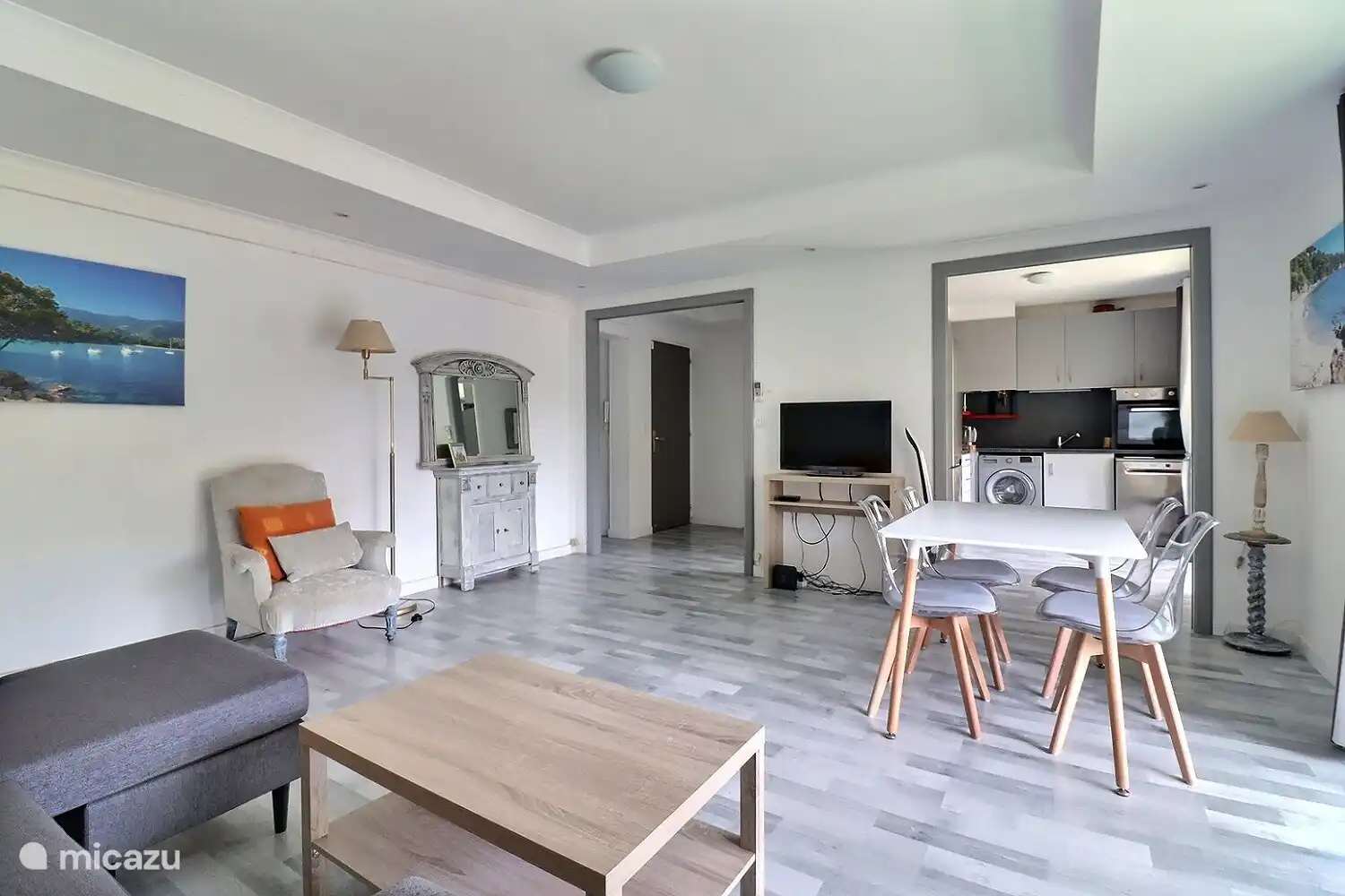 Living room facing south on double balcony and large wooded square