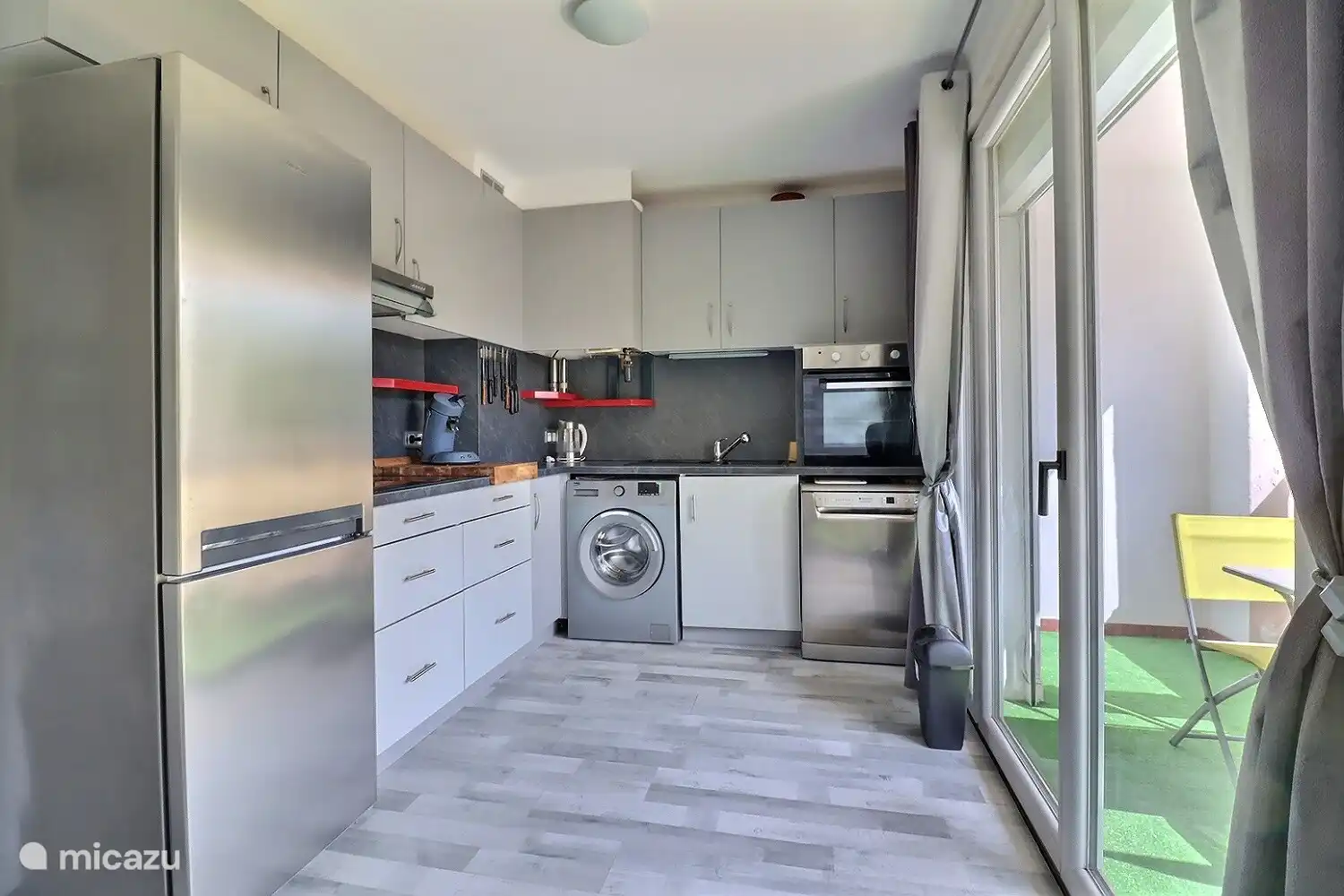 Kitchen facing south on double balcony and large wooded square