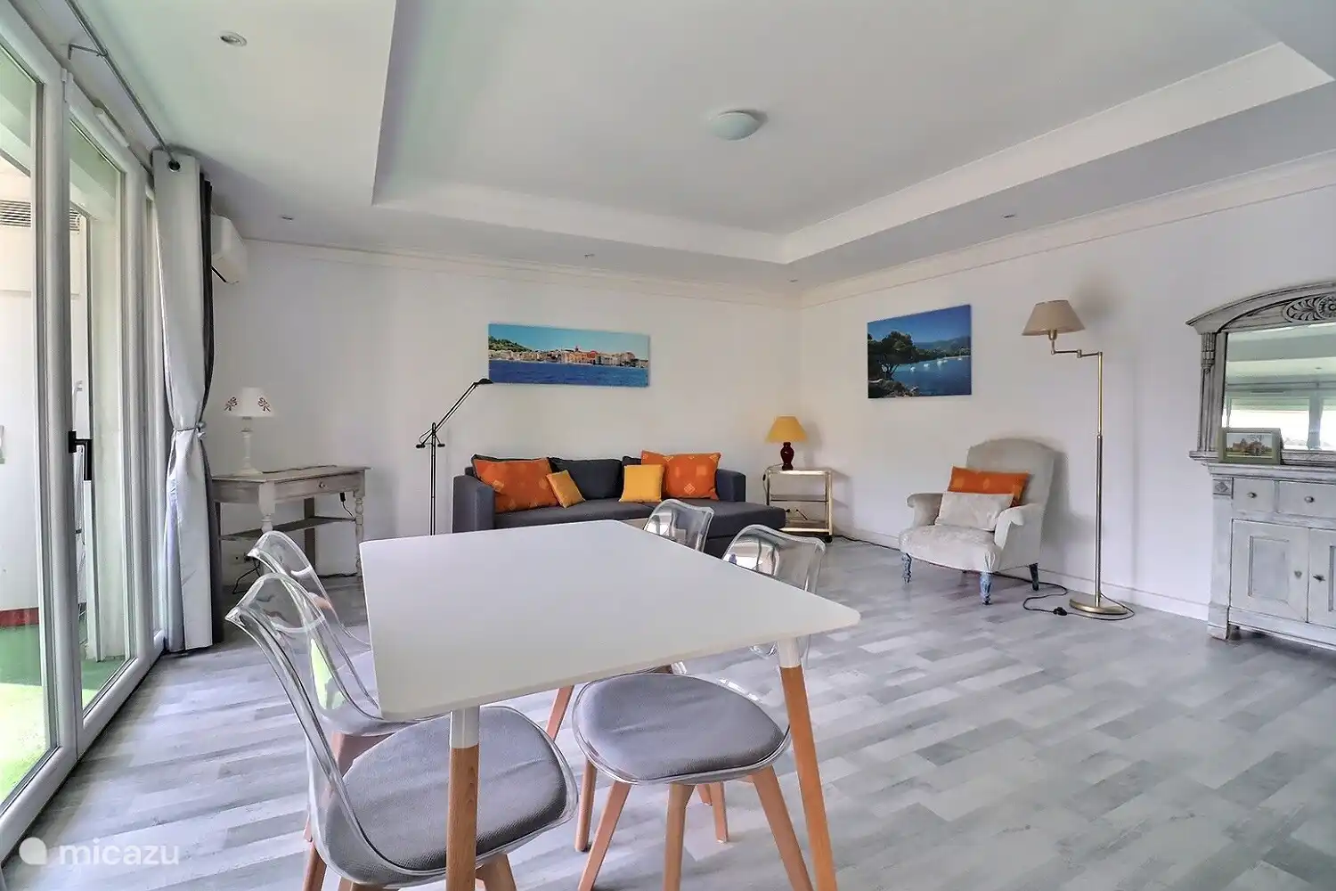 Living room facing south on double balcony and large wooded square