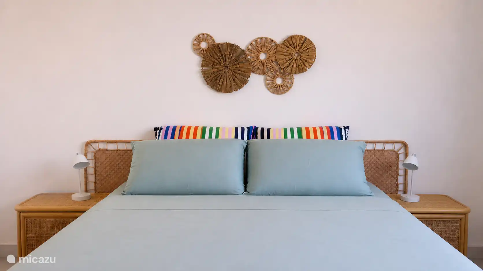 Queensize bed met pocketvering en cloudpillow topmatras, katoen beddengoed en verschillende dikke kussens.