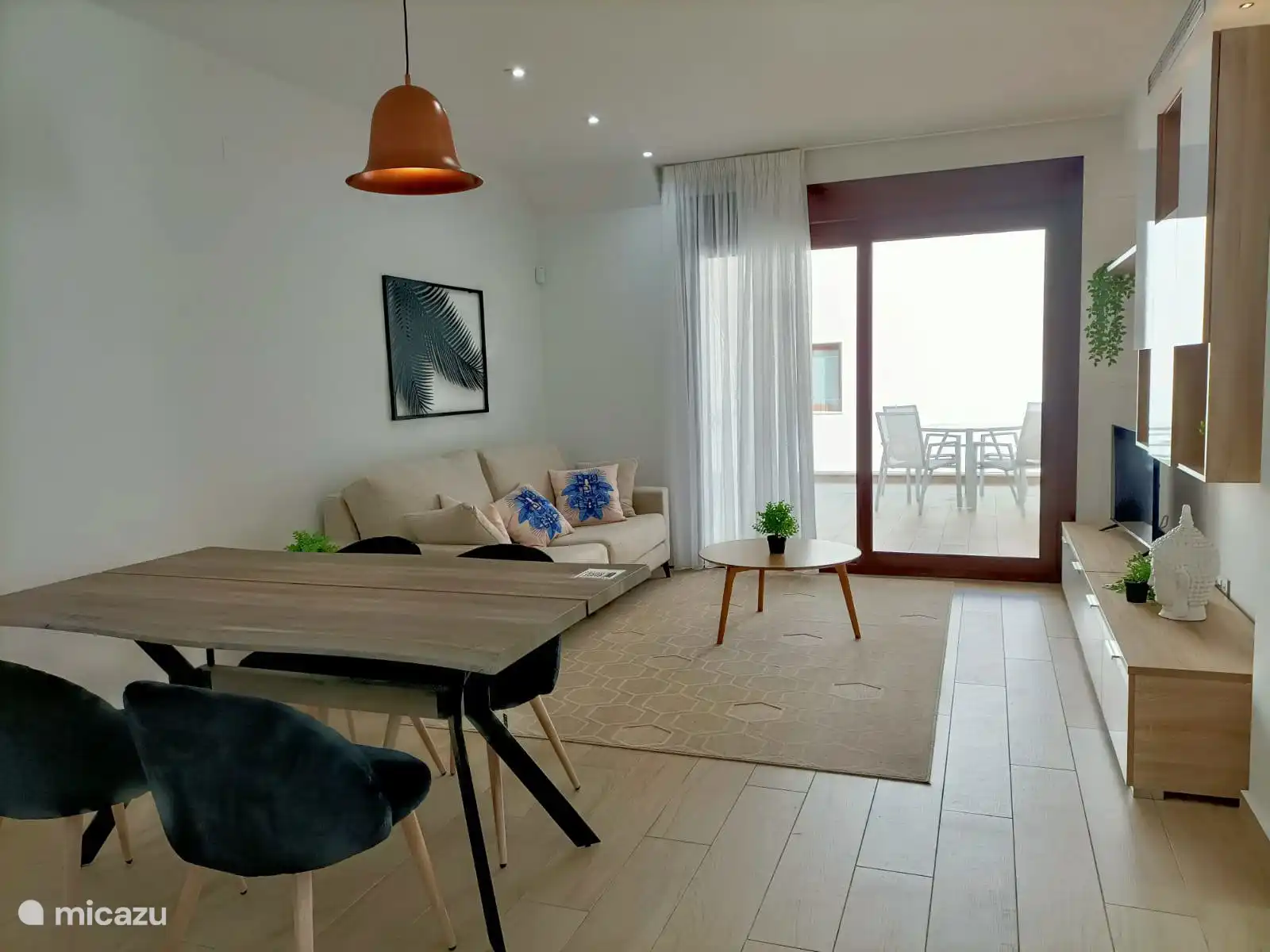 The living room connects nicely to the open kitchen, which provides a spacious and modern feeling.