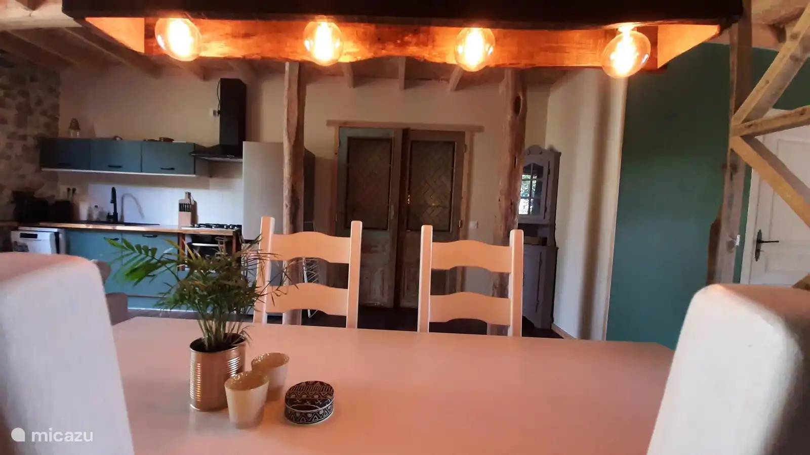 Reclaimed doors and a hand made dining table lamp offer a nostalgic ambiance