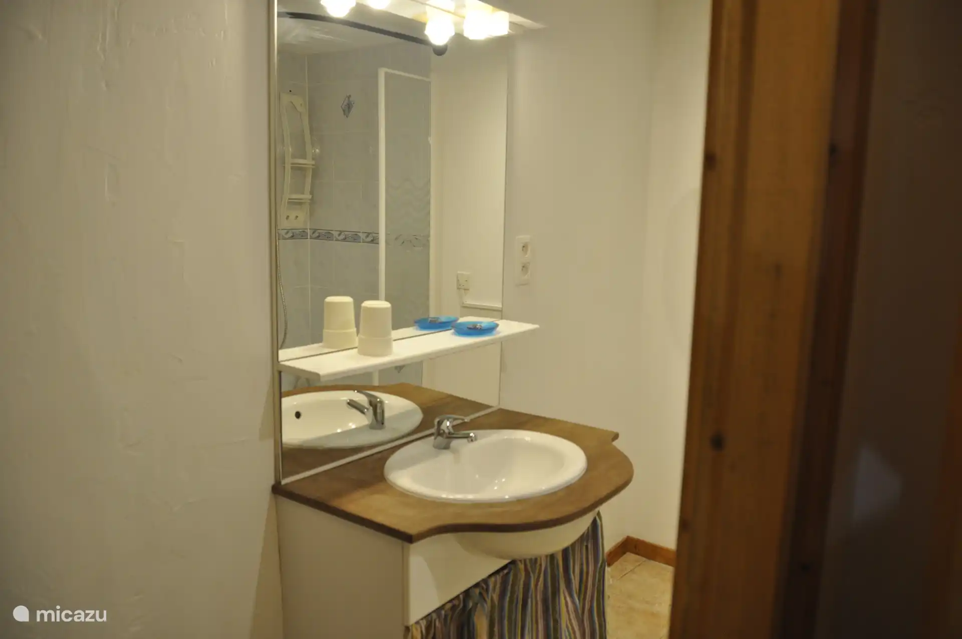 Bathroom with shower and washing machine. There is also a separate toilet.