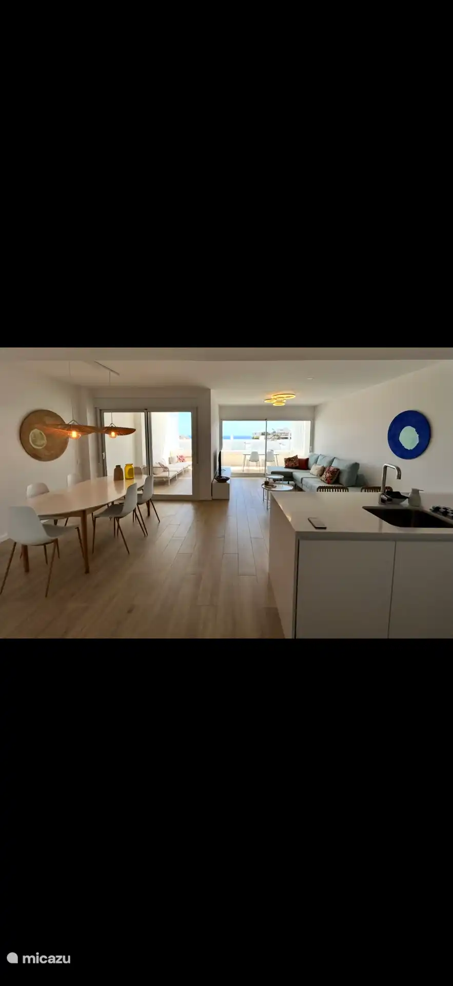 Our living room with modern kitchen and spacious terrace with sea view.