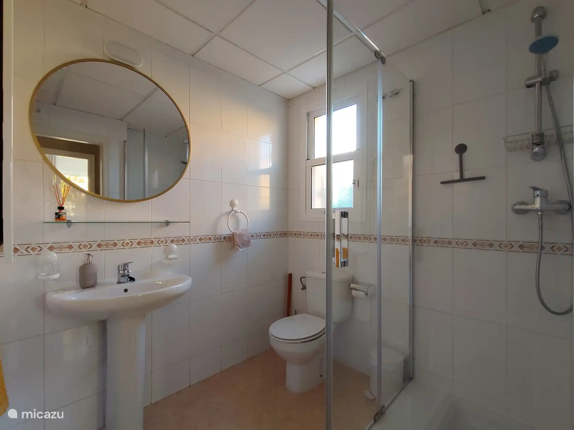 Baño de abajo con ducha, inodoro y lavabo