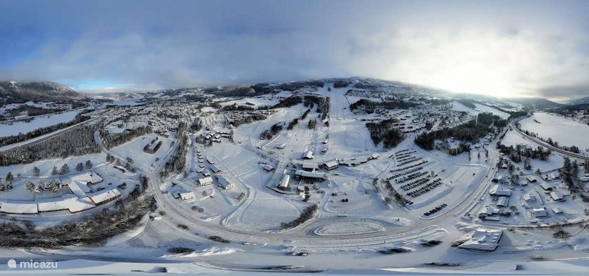 Overview of the ski area at the bottom of the mountain. The apartment is located right halfway next to the slope and above the parking lot