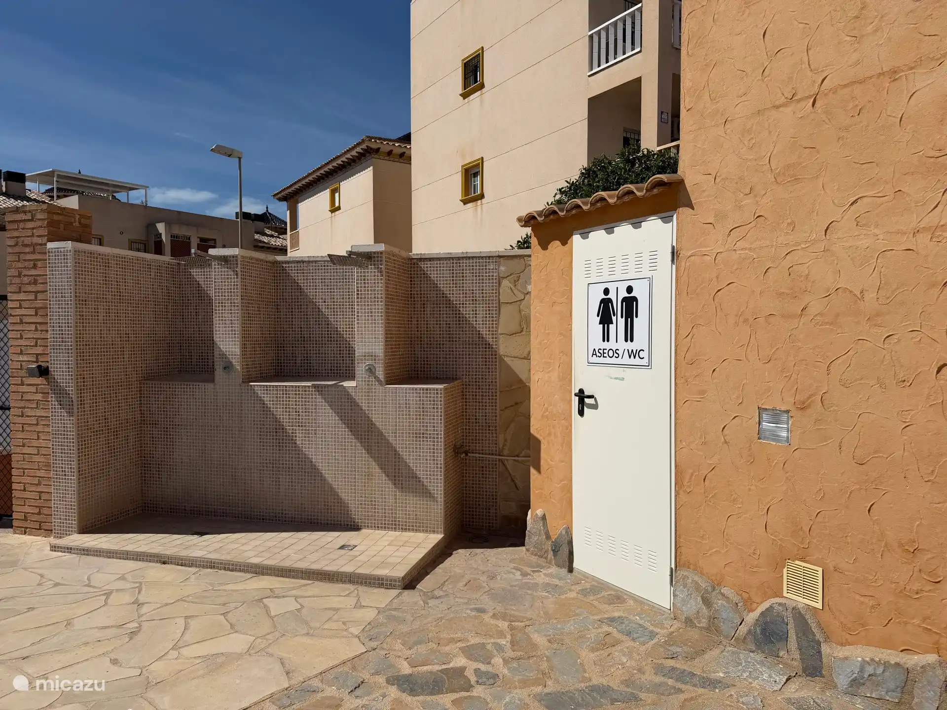 Outdoor shower and toilet at the community pool