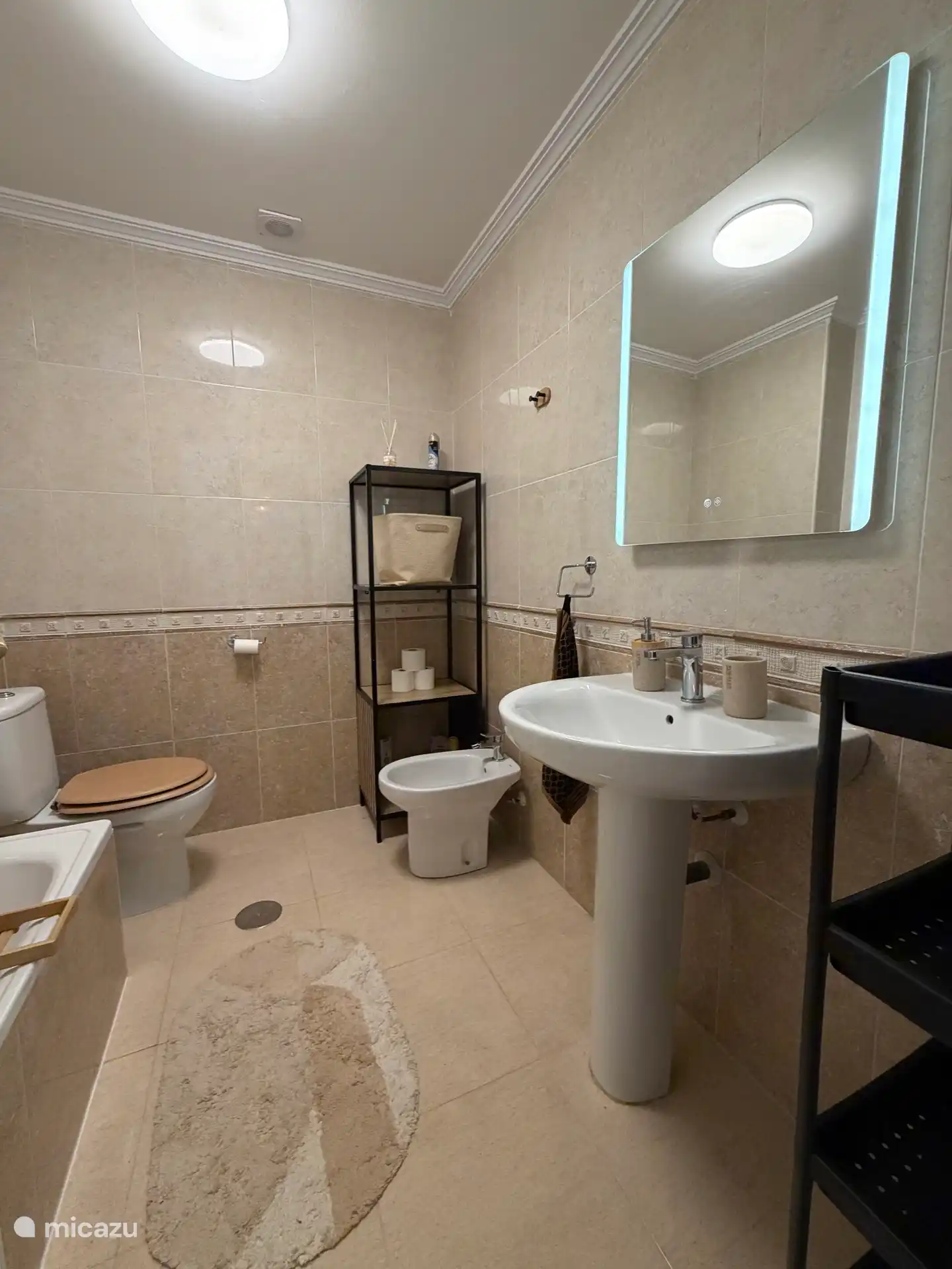 Bathroom with toilet, bidet, bath/shower