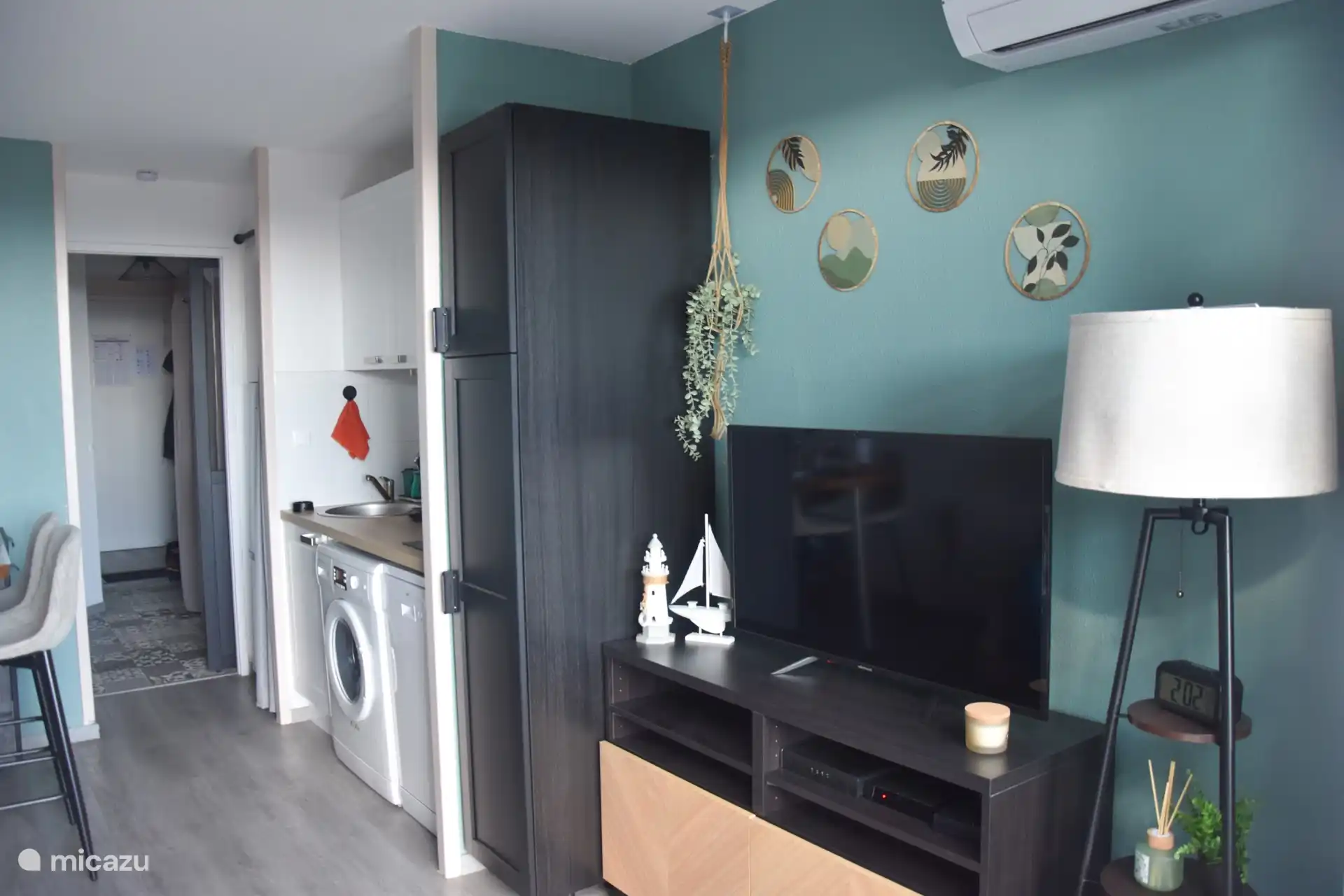 The living room, with its TV area and air conditioning