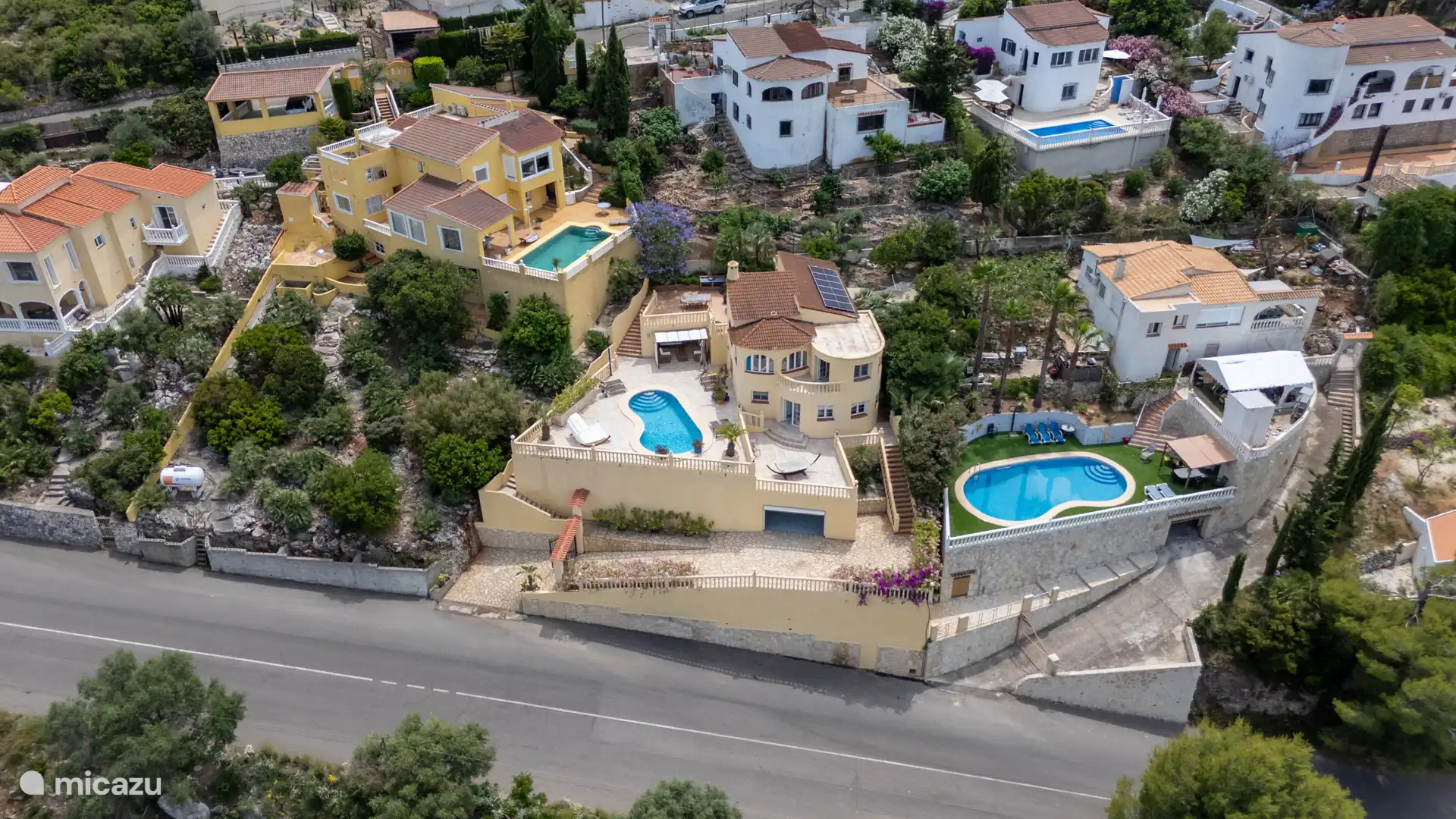 Vue aérienne de Casa Oliva — 800 m² de terrain privé avec piscine privée, plusieurs terrasses et espace vert dans un quartier paisible.