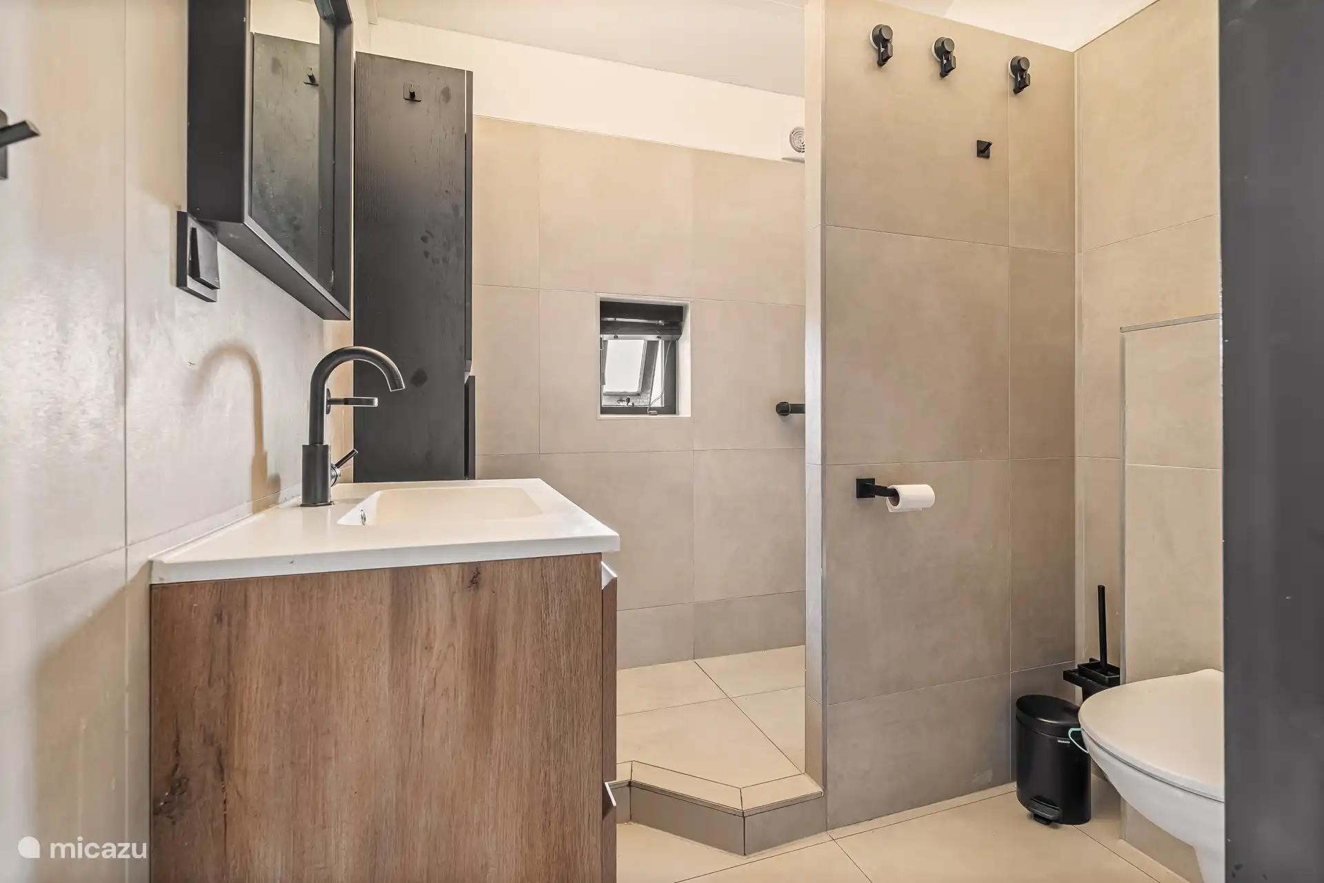 Modern bathroom with walk-in shower and luxurious finish.