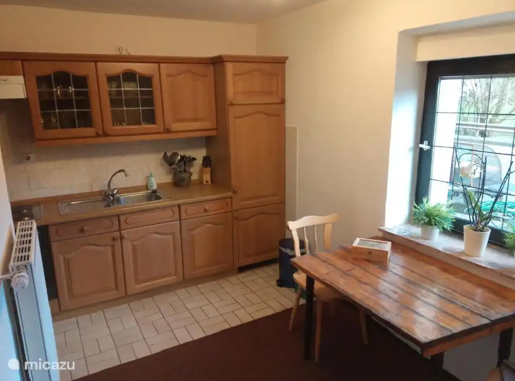 La cocina con una pequeña mesa de comedor para 4 personas
