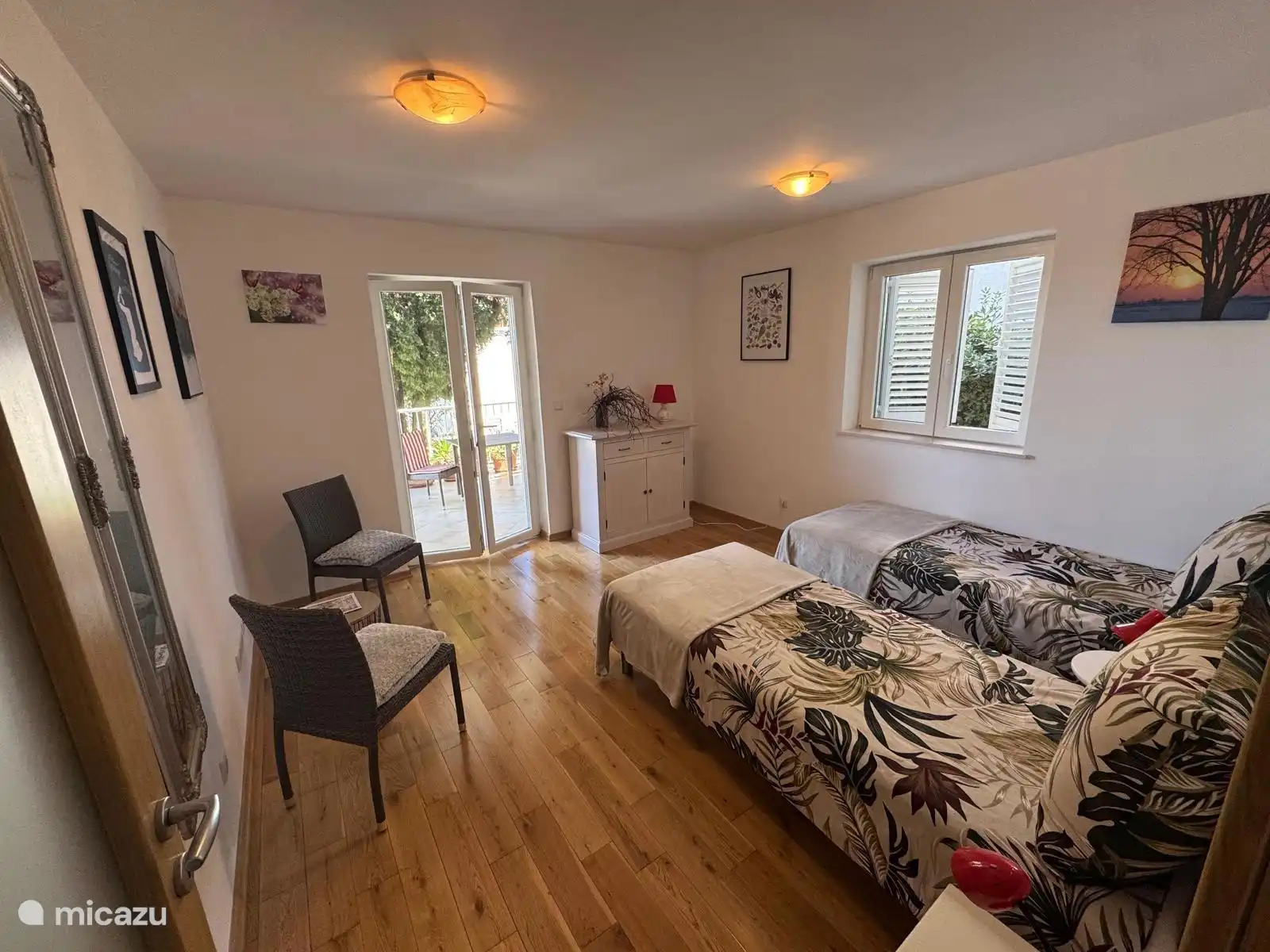 El dormitorio principal del apartamento Maja con dos camas individuales puede colocarse uno al lado del otro como cama doble bajo demanda. La sala también cuenta con dos sillones. Esta habitación tiene acceso a una terraza privada