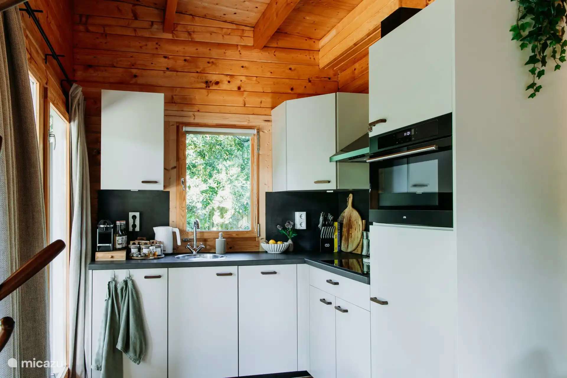 Fully equipped kitchen with induction hob, combi oven, fridge with freezer, dishwasher, Nespresso machine, milk frother, kettle, toaster and mixer.