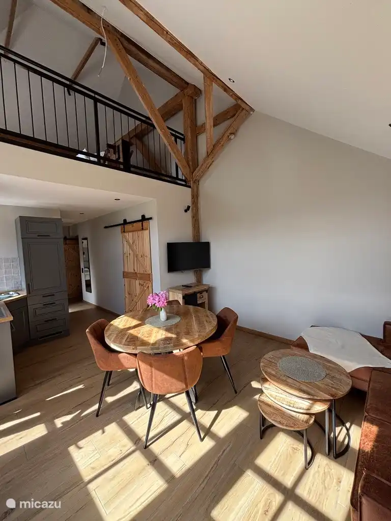 Living room with original wooden beams from the old pigsty