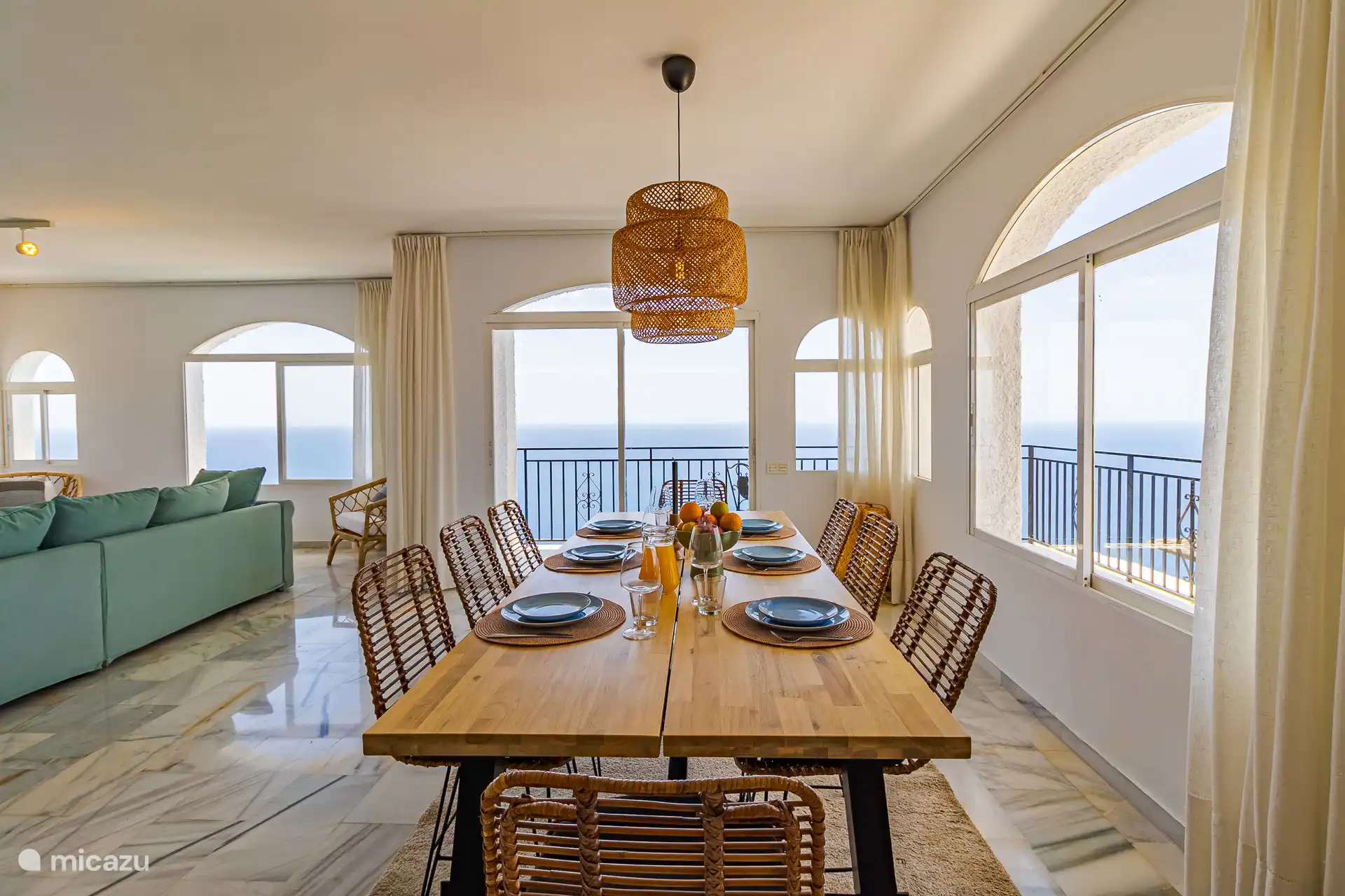 Royale eettafel in de lichte woon/eetkamer met rondom uitzicht op de Middellandse Zee