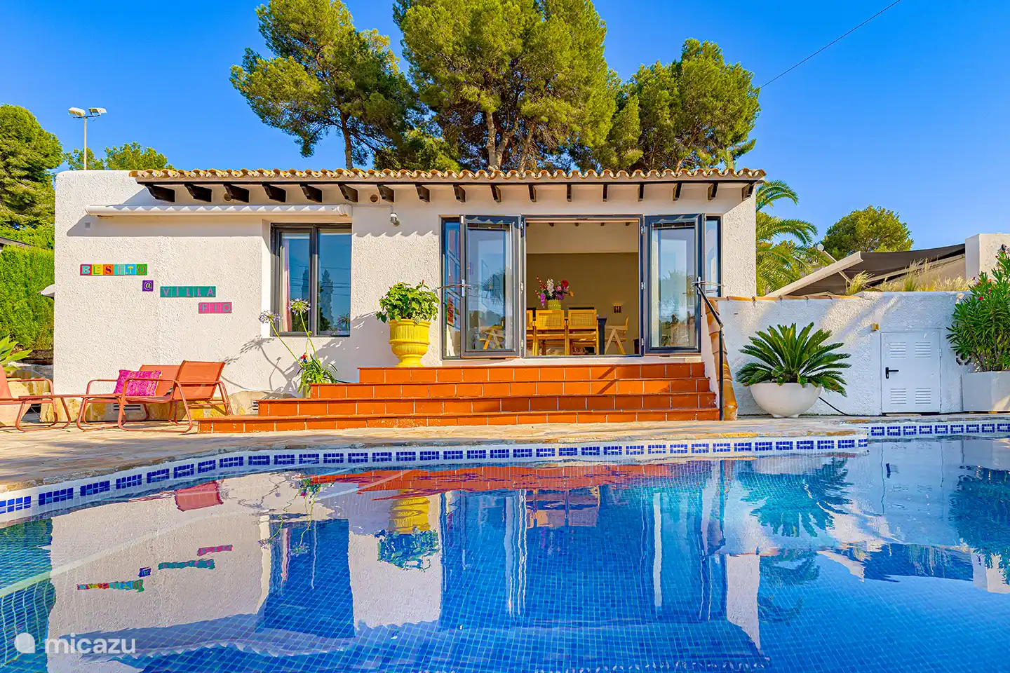 Vom Pool aus hat man einen Blick auf die Villa und die großzügige Terrasse. Alles dreht sich darum, sich zu entspannen, zu genießen und gemeinsam draußen zu leben.