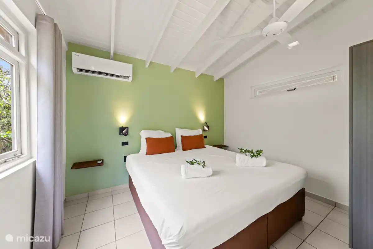 Primer dormitorio con aire acondicionado y ventilador