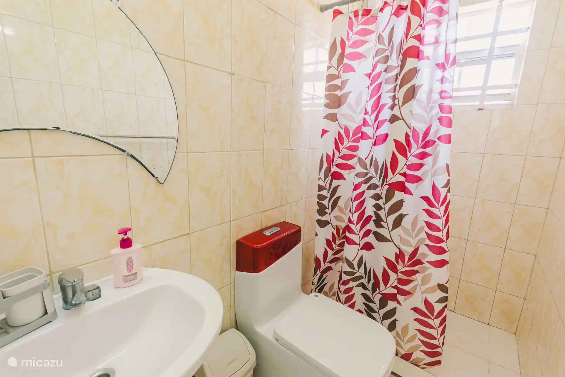 bathroom with sink, toilet and shower with hot water