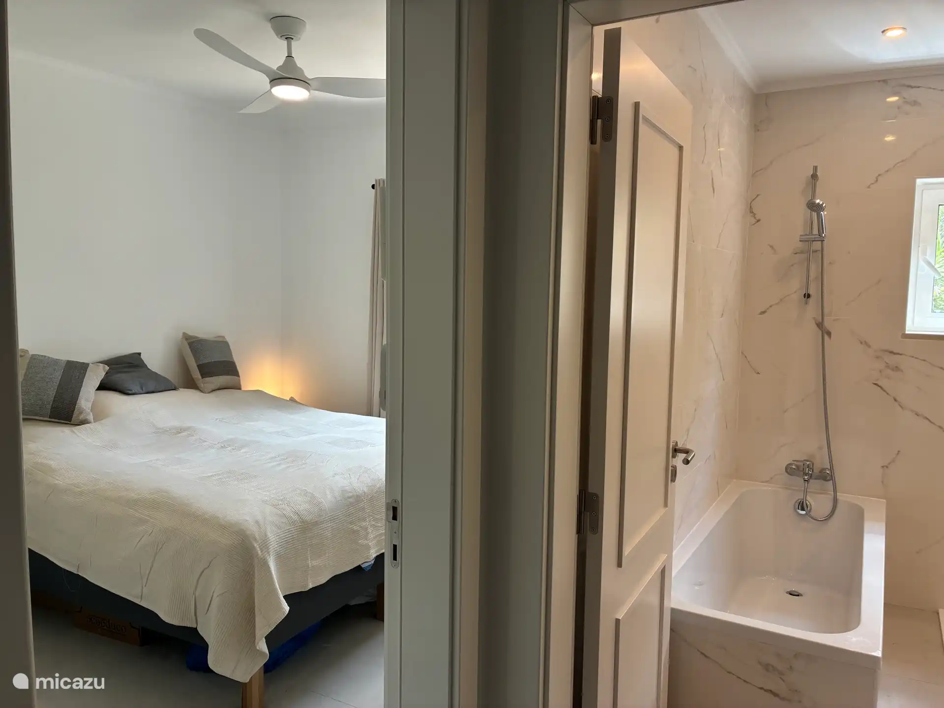 Slaapkamer 1 ligt naast de badkamer met toilet, wastafel en douche