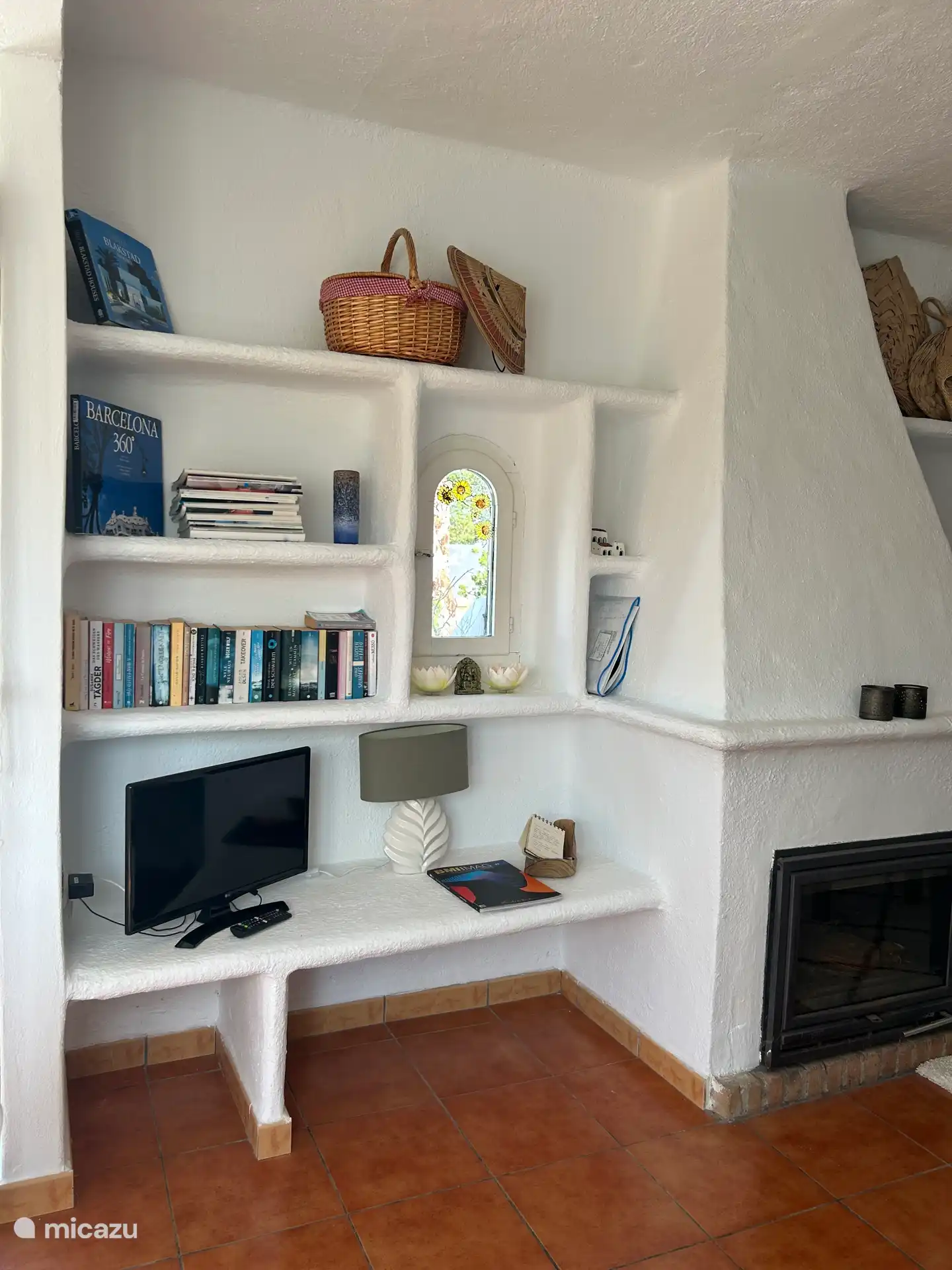 Living room corner with numerous books and smart TV