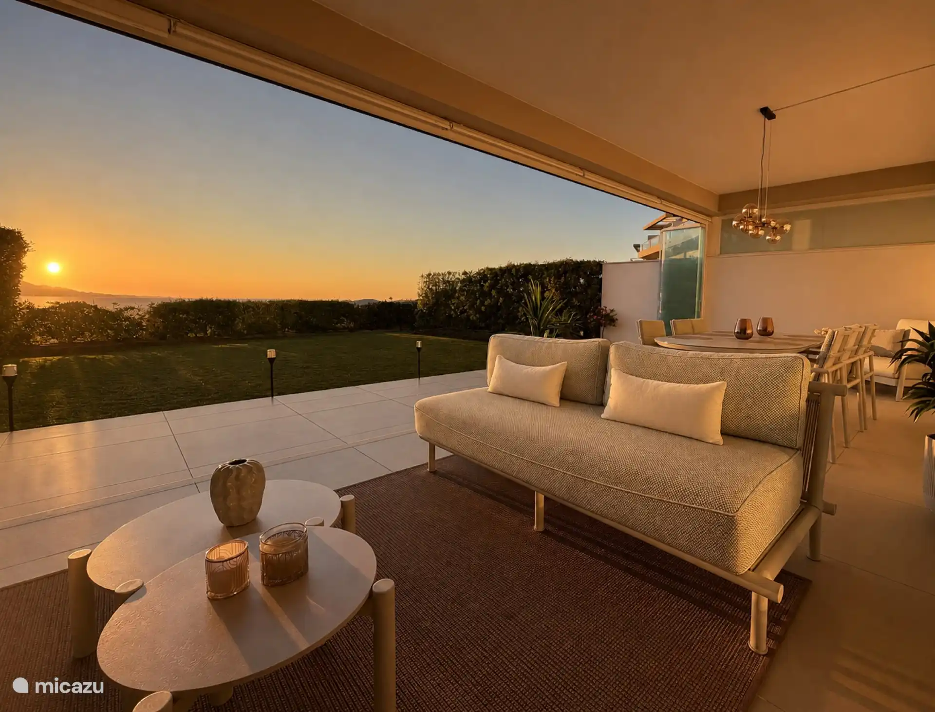 Sunset terrace with dining area and evening light over the mountains