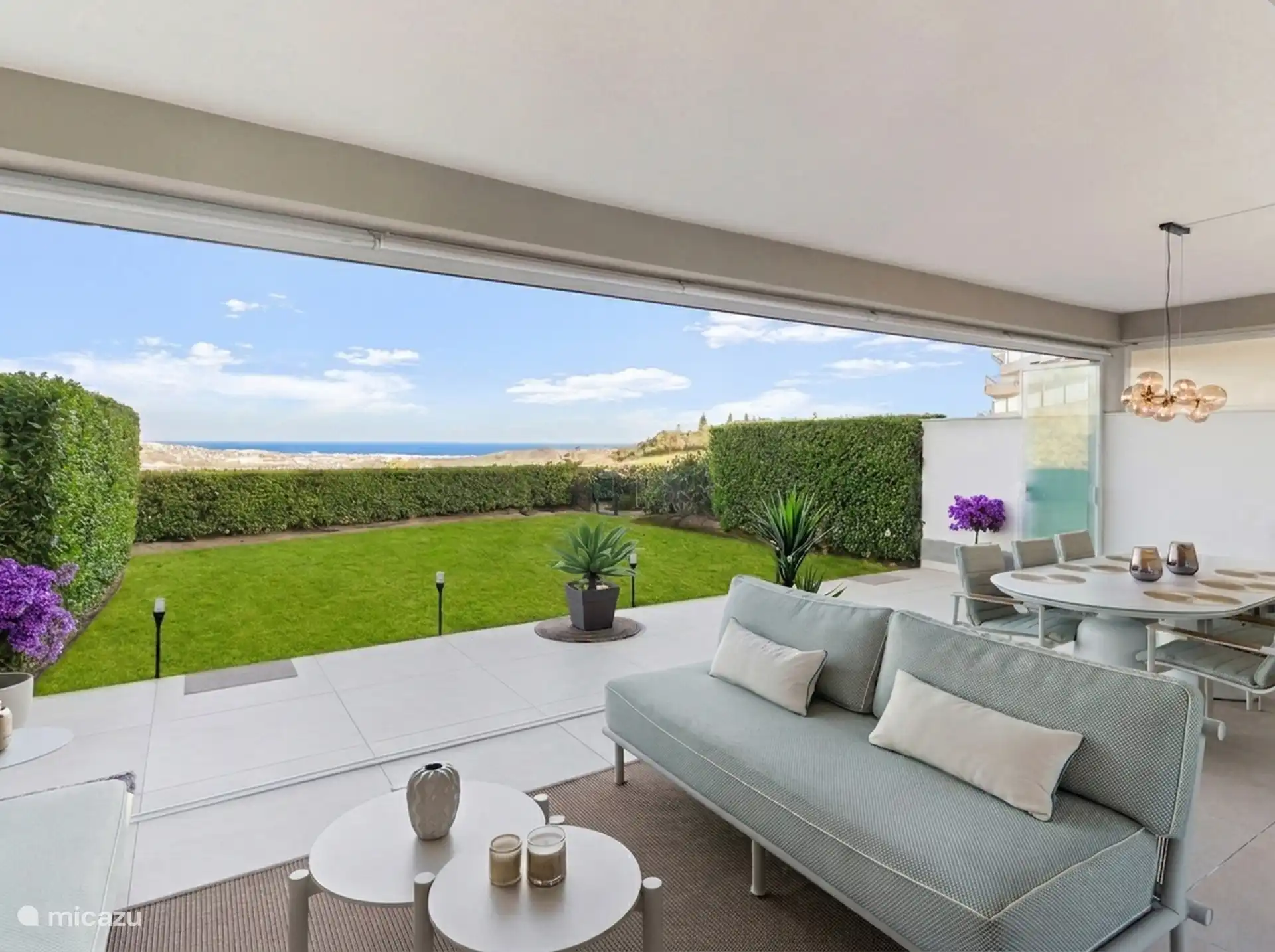 Terrace with lounge sofa and dining table on the private garden