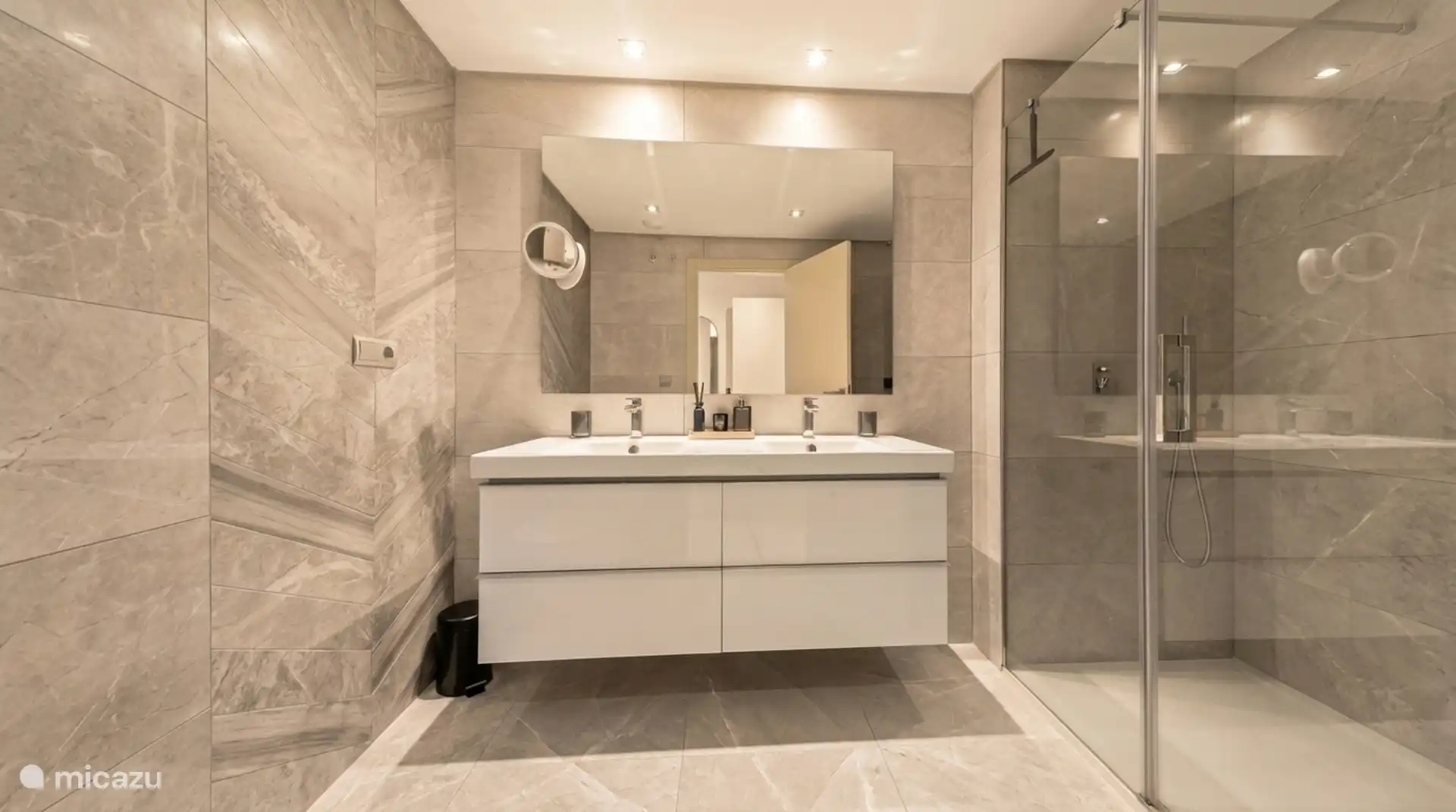 Bathroom with double sink and spacious walk-in shower