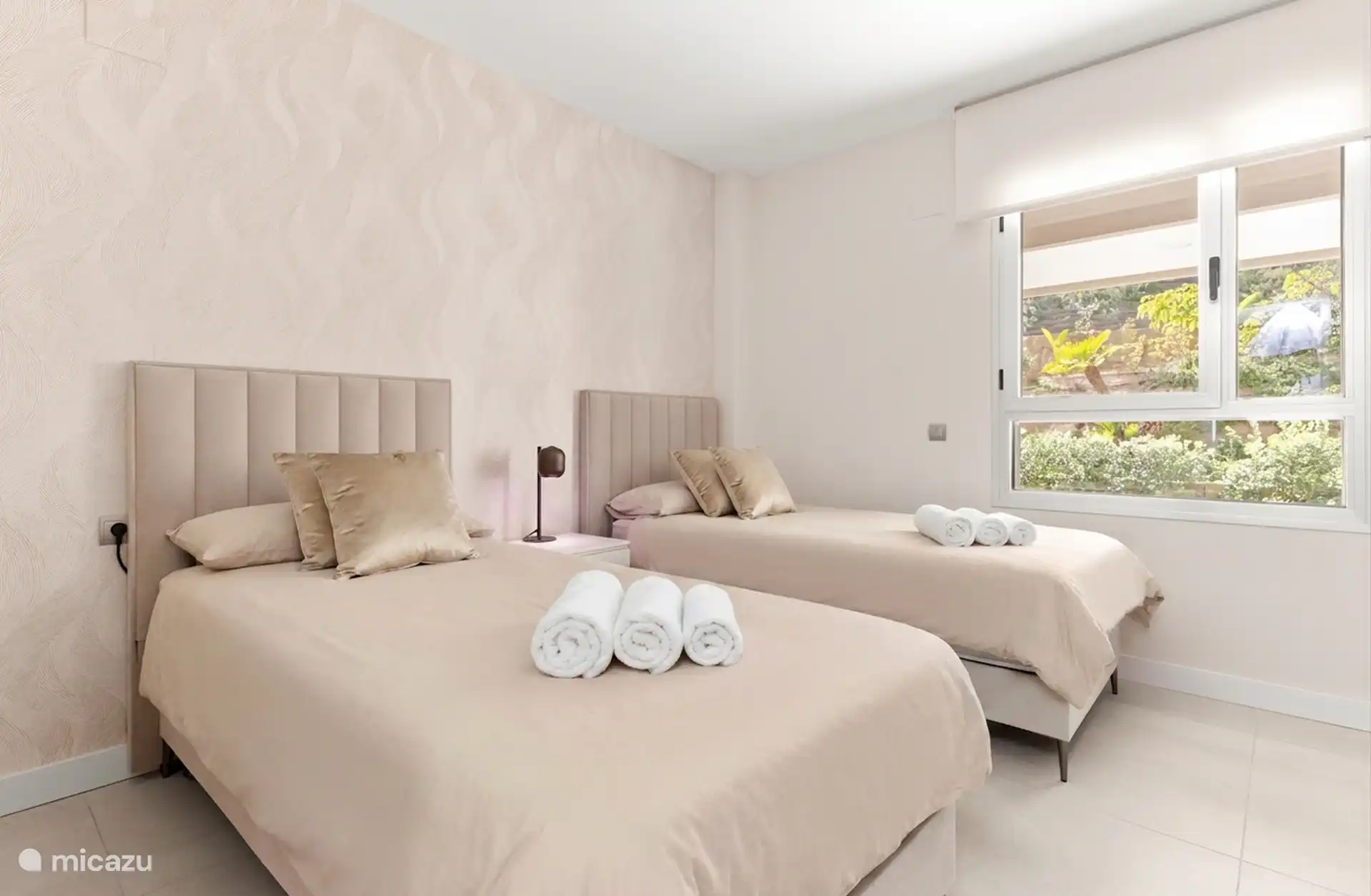 Second bedroom with two single beds and fresh towels